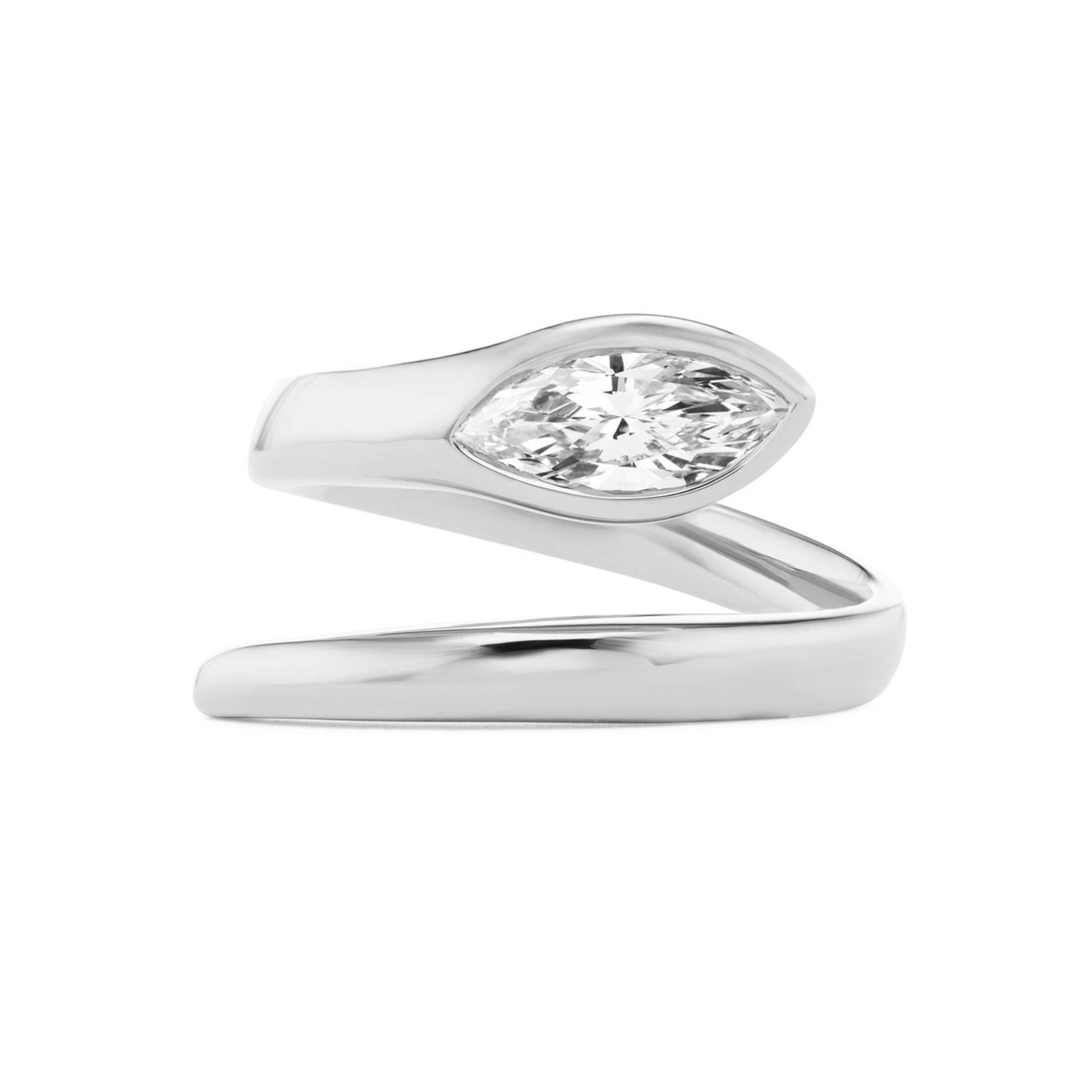 The Serpent Wraparound Ring with Marquise Diamond is a silver ring designed in a modern, minimalist style, featuring a polished metal band that wraps around the finger and showcases a stunning marquise-cut clear gemstone. Available in Size 6.