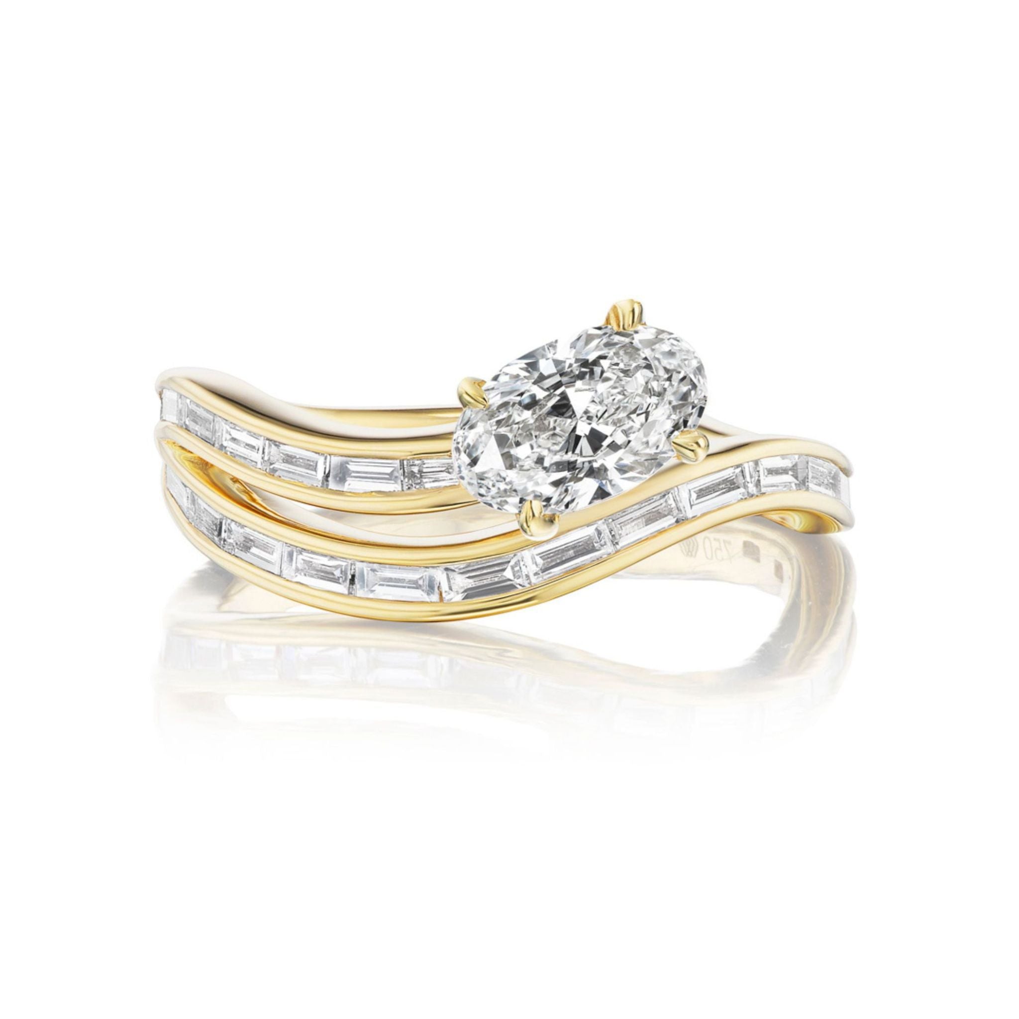 A breathtaking Snake Wave Channel Set Baguette Diamond Ring with Oval Diamond in 18k gold, featuring a striking oval diamond center and two wavy bands adorned with sparkling baguette diamonds, beautifully showcased against a white background.