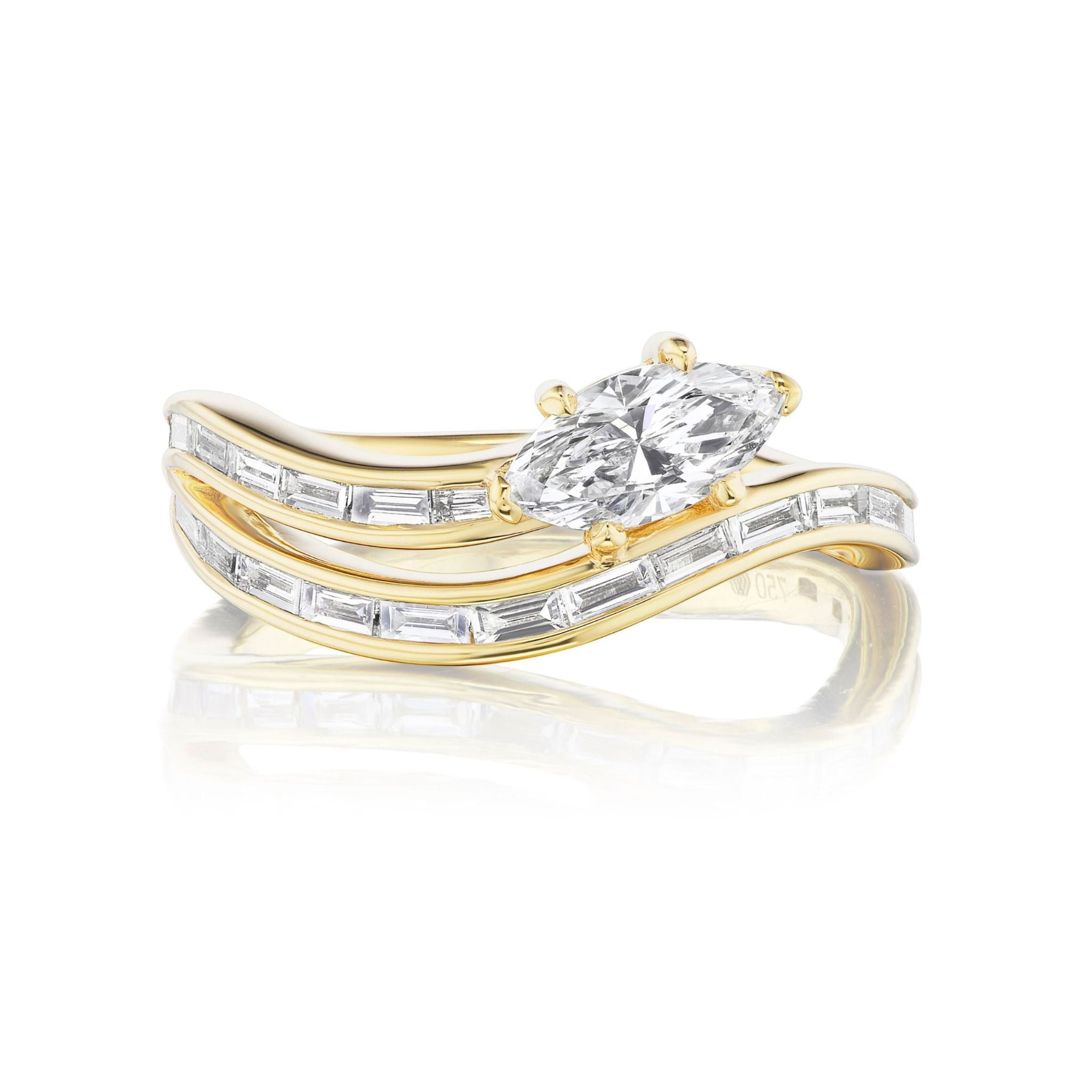 Introducing the Snake Wave Channel Set Baguette Diamond Ring with Marquise Diamond in Yellow Gold, a striking 18k yellow gold ring showcasing two marquise-cut diamonds at its center, gracefully flanked by wavy bands adorned with channel-set baguette diamonds.