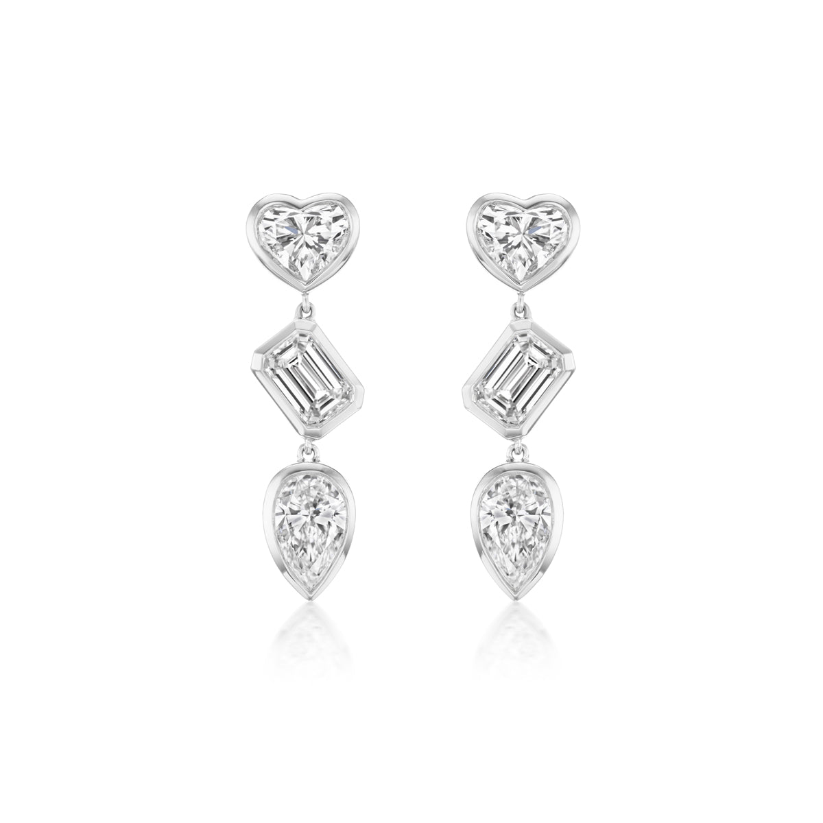 The Bezel Set Mixed Shape Diamond Drop Earrings feature three diamonds per earring—a heart-shaped top, a baguette-cut center, and a teardrop bottom—all set in silver.