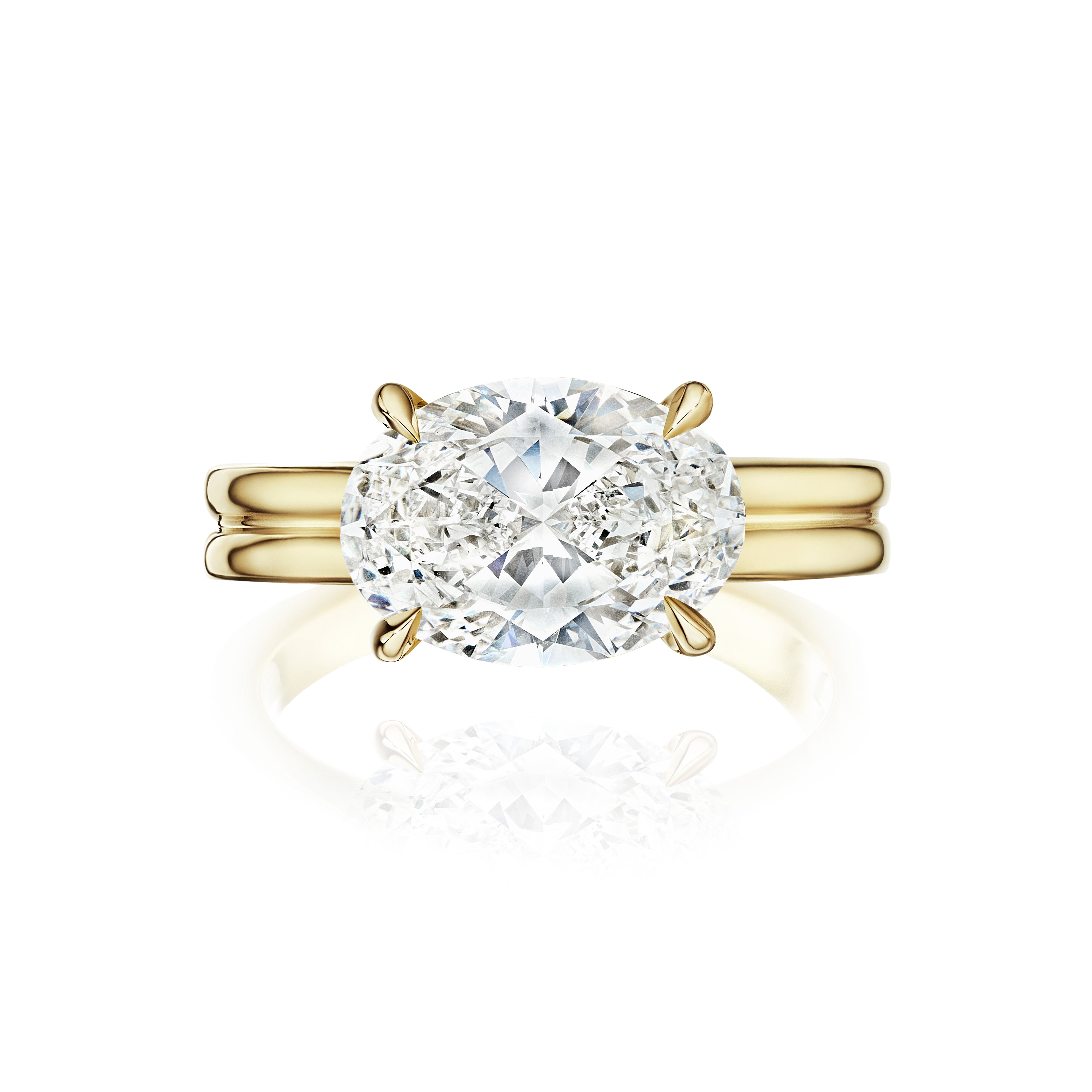 The East-West Oval Diamond Double Band Engagement Ring in yellow gold features a large oval-cut diamond solitaire set in four prongs, shown against a white background.