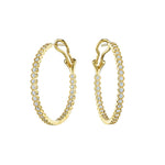 The Bezel Set Hexagon Hoops with Round Brilliant Diamonds are 18K gold earrings featuring a hexagonal design and sparkling round diamonds along the edge, secured with latch back closures.