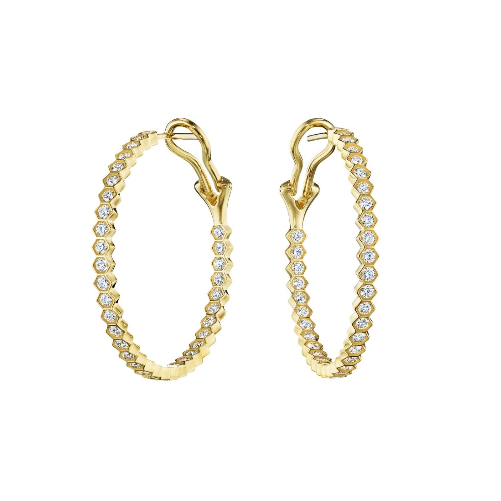 The Bezel Set Hexagon Hoops with Round Brilliant Diamonds are 18K gold earrings featuring a hexagonal design and sparkling round diamonds along the edge, secured with latch back closures.