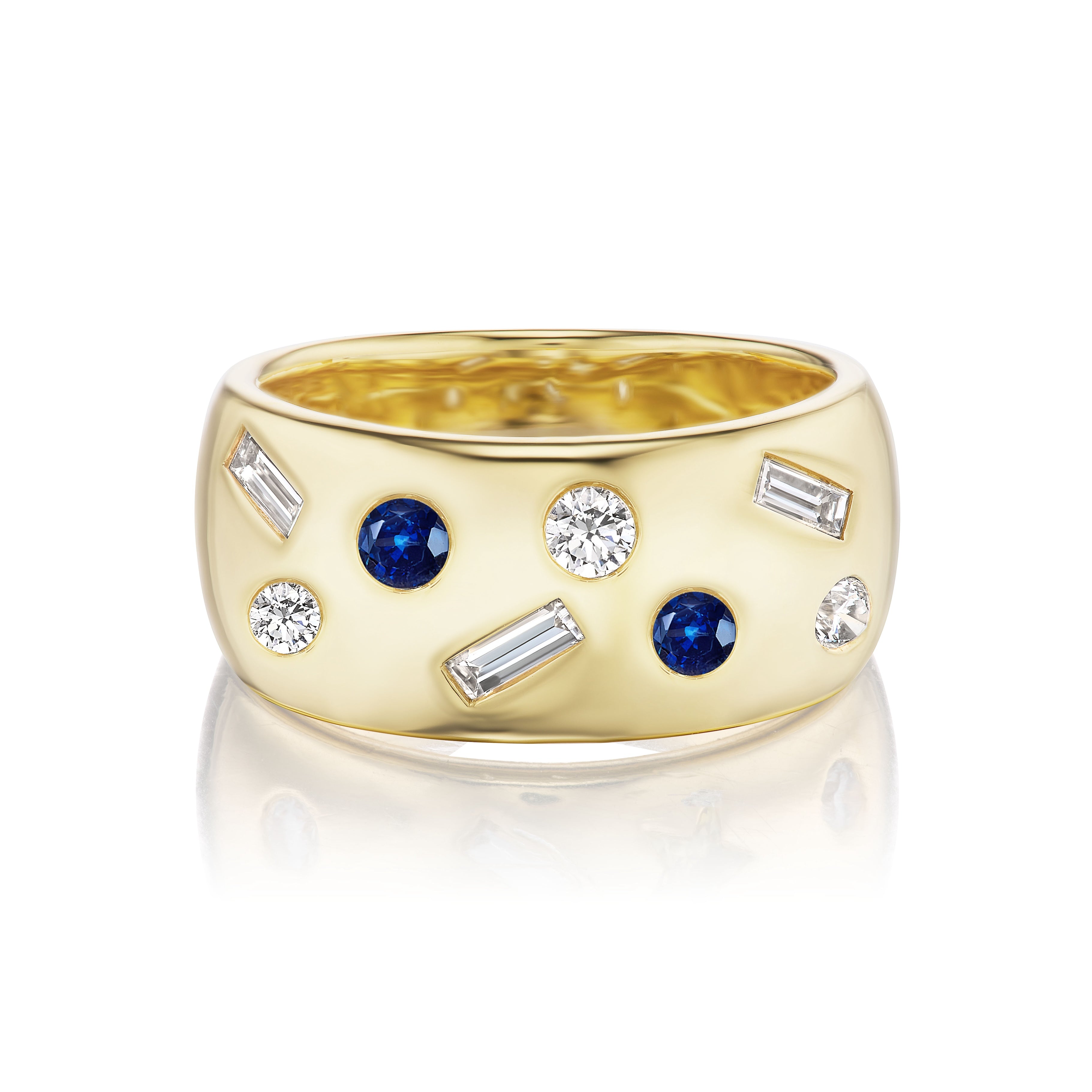 The Mixed Shape Burnish Set Diamond and Sapphire Cigar Band in Yellow Gold features a wide 18K band adorned with round blue sapphires, round white diamonds, and rectangular baguette diamonds scattered across its surface.
