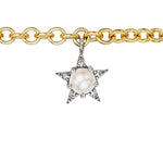 A beautiful yellow gold charm bracelet from the America250 capsule collection, featuring rubies, pearls, sapphires, and diamonds—an elegant statement piece.