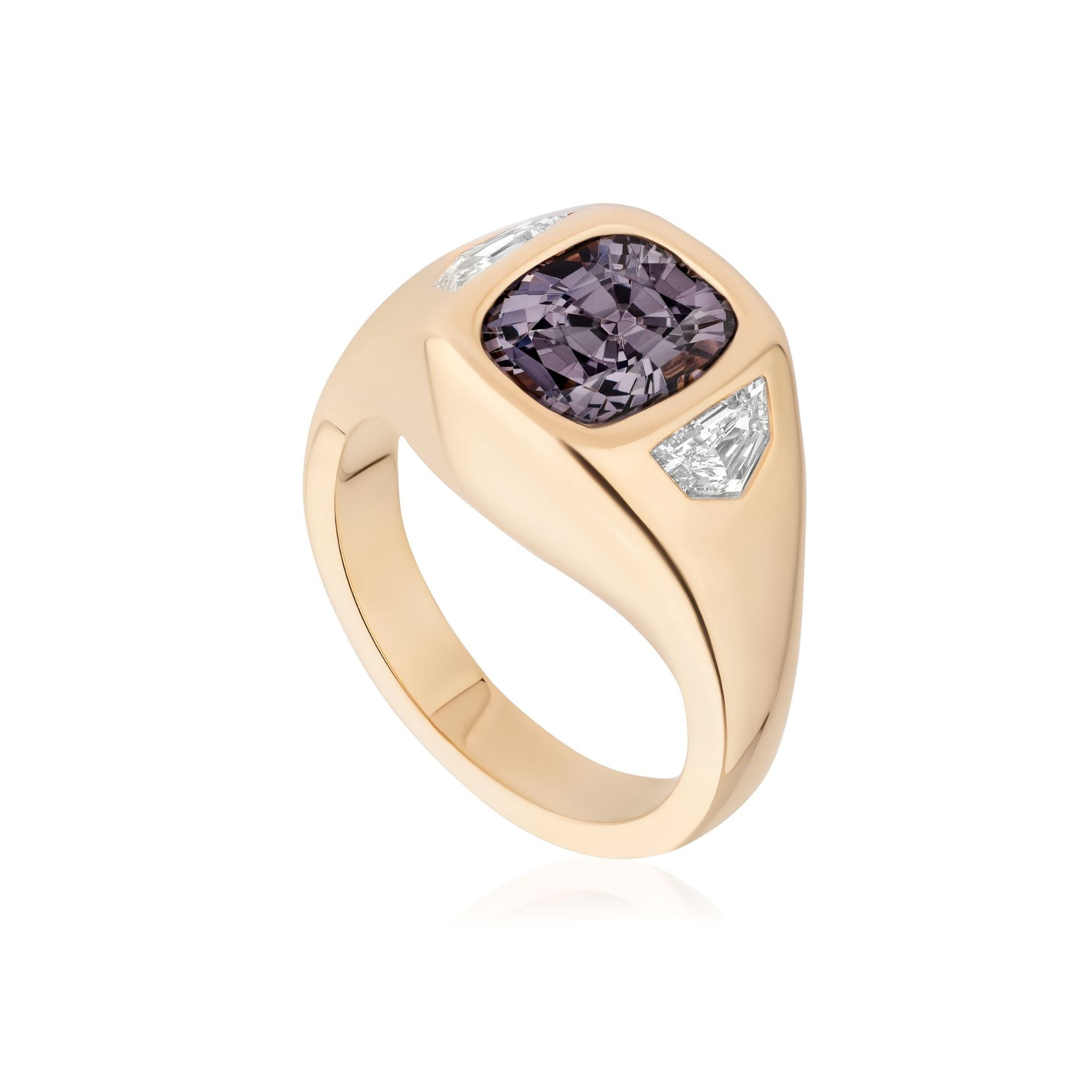 Introducing the Cushion Cut Spinel and Diamond Epaulette Side Stone Gypsy Ring in Yellow Gold—a breathtaking 18k yellow gold ring highlighted by a richly hued, cushion cut purple spinel at its center. Two triangular diamond side stones accentuate the centerpiece, all beautifully showcased against a white background.