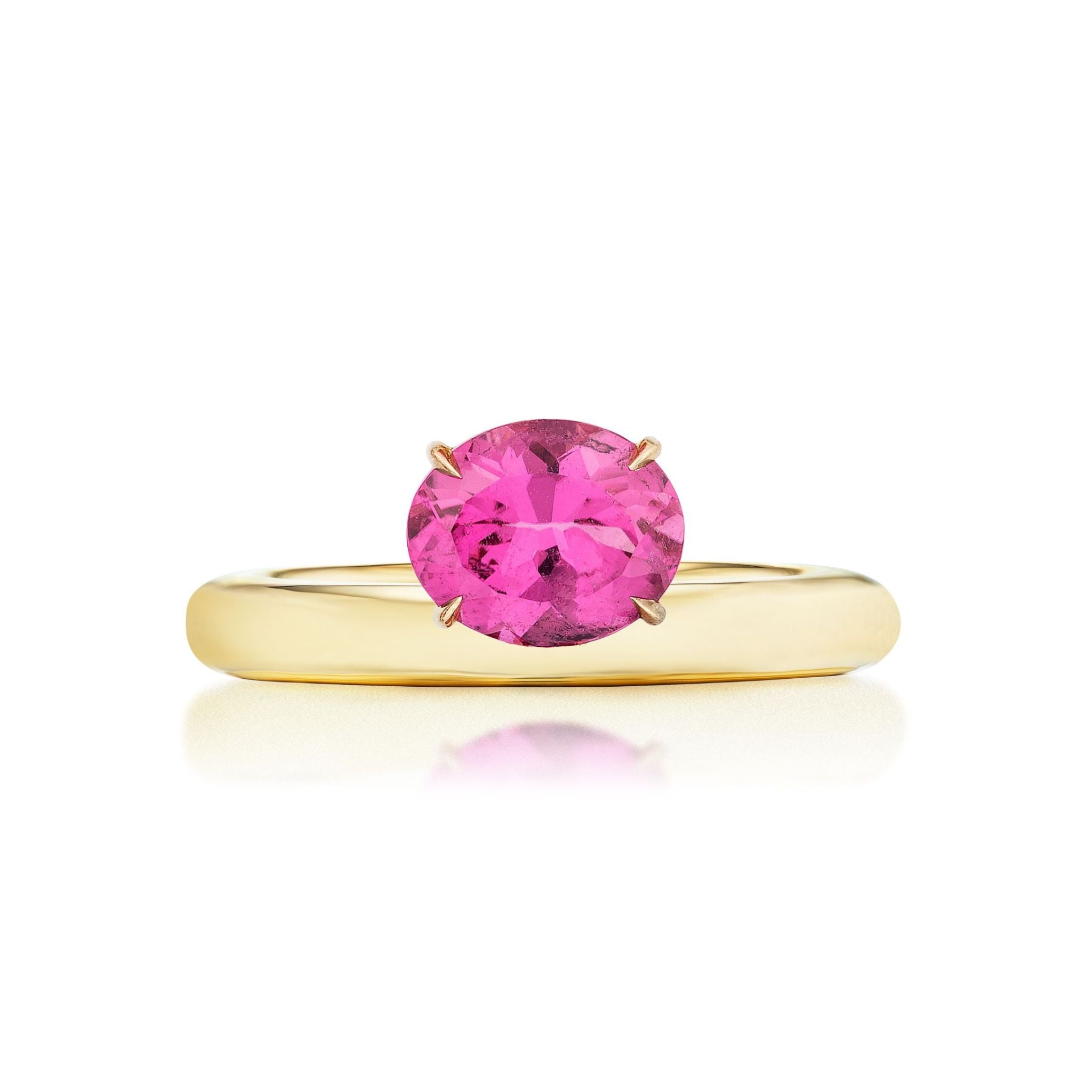 The East-West Set Pinky Ring in Yellow Gold features an oval pink sapphire in a simple four-prong setting, crafted from 18k yellow gold and displayed on a plain white background.