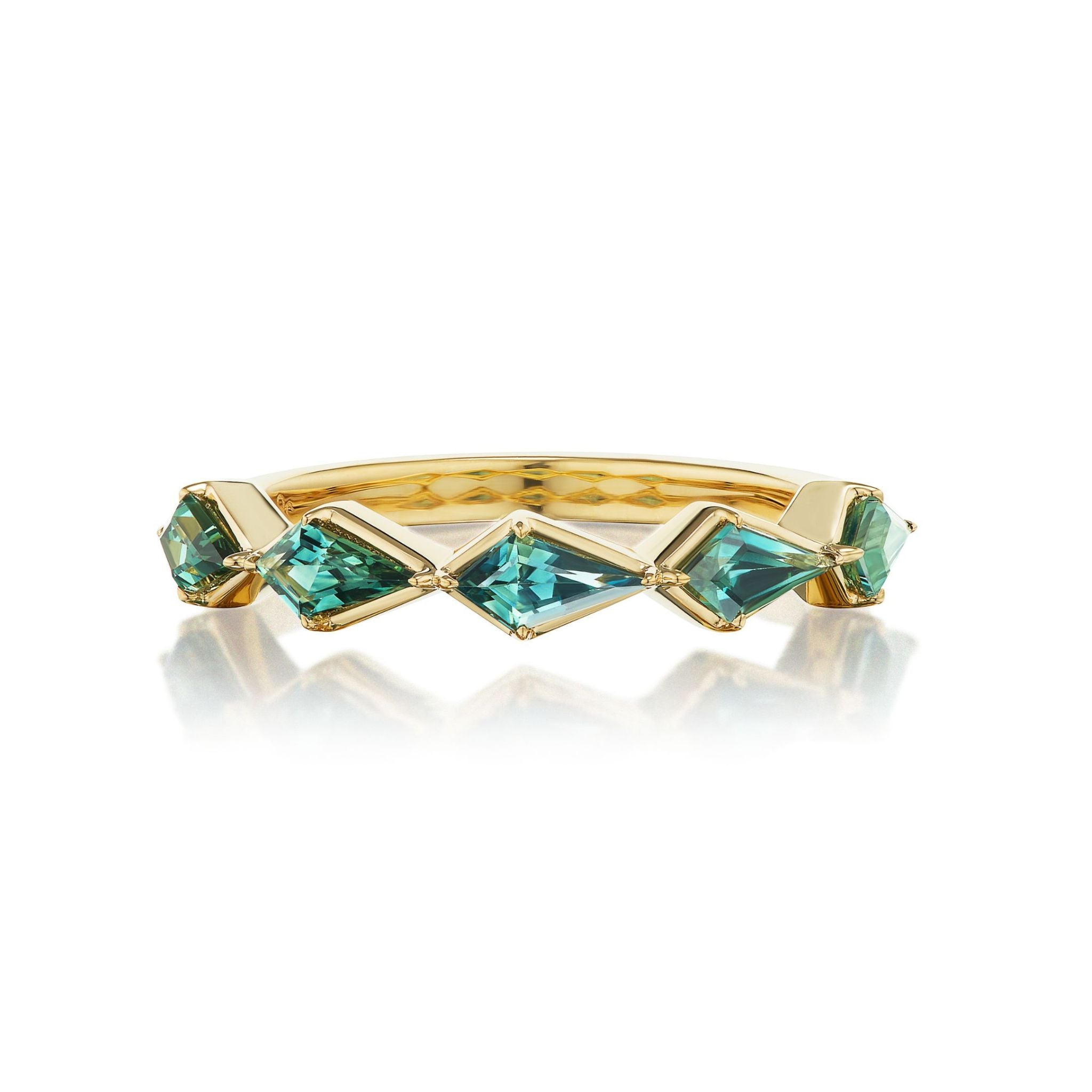 Chasing Kites Emerald Half Eternity Band in Yellow Gold displayed against a white background with a subtle reflection beneath, featuring five geometric kite-shaped emeralds bezel set in an 18k yellow gold ring arranged in a unique zigzag pattern.