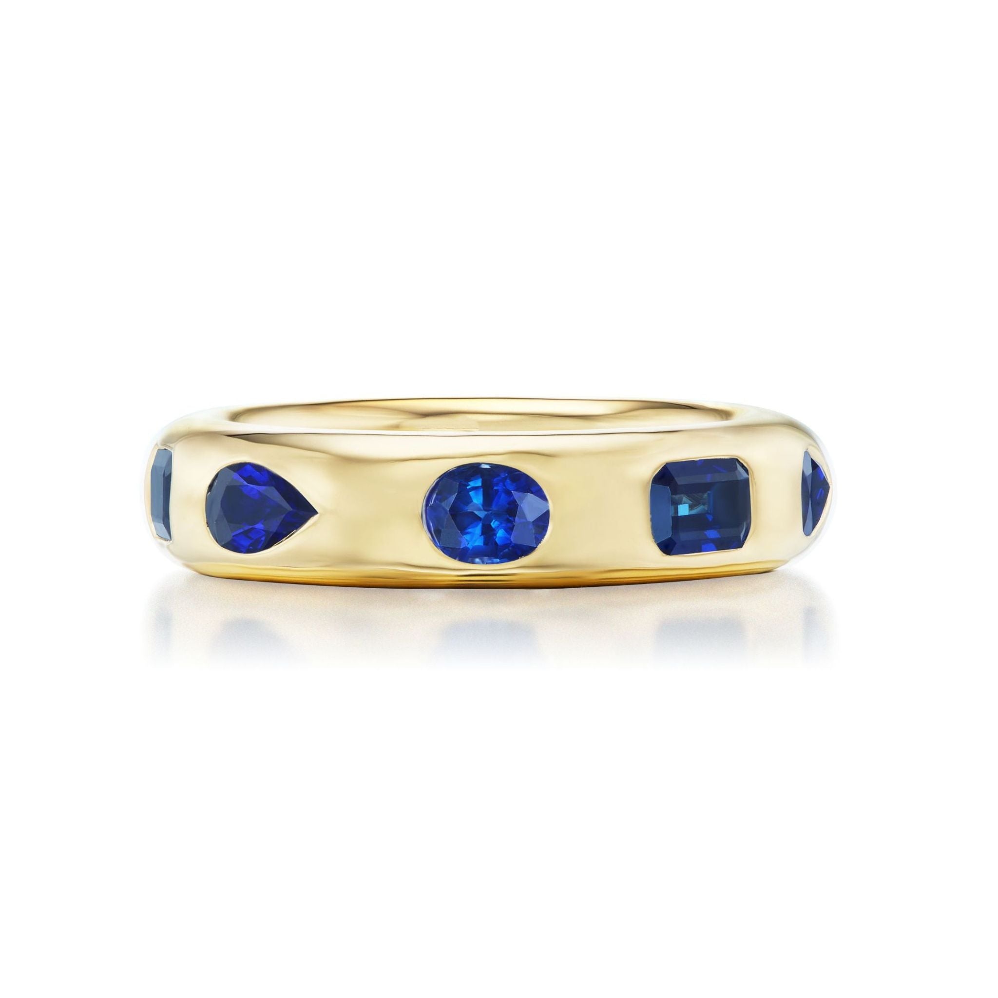 Wedding Band in Yellow Gold featuring burnish set sapphires of mixed shapes—round, pear, and oval—evenly spaced around the band.