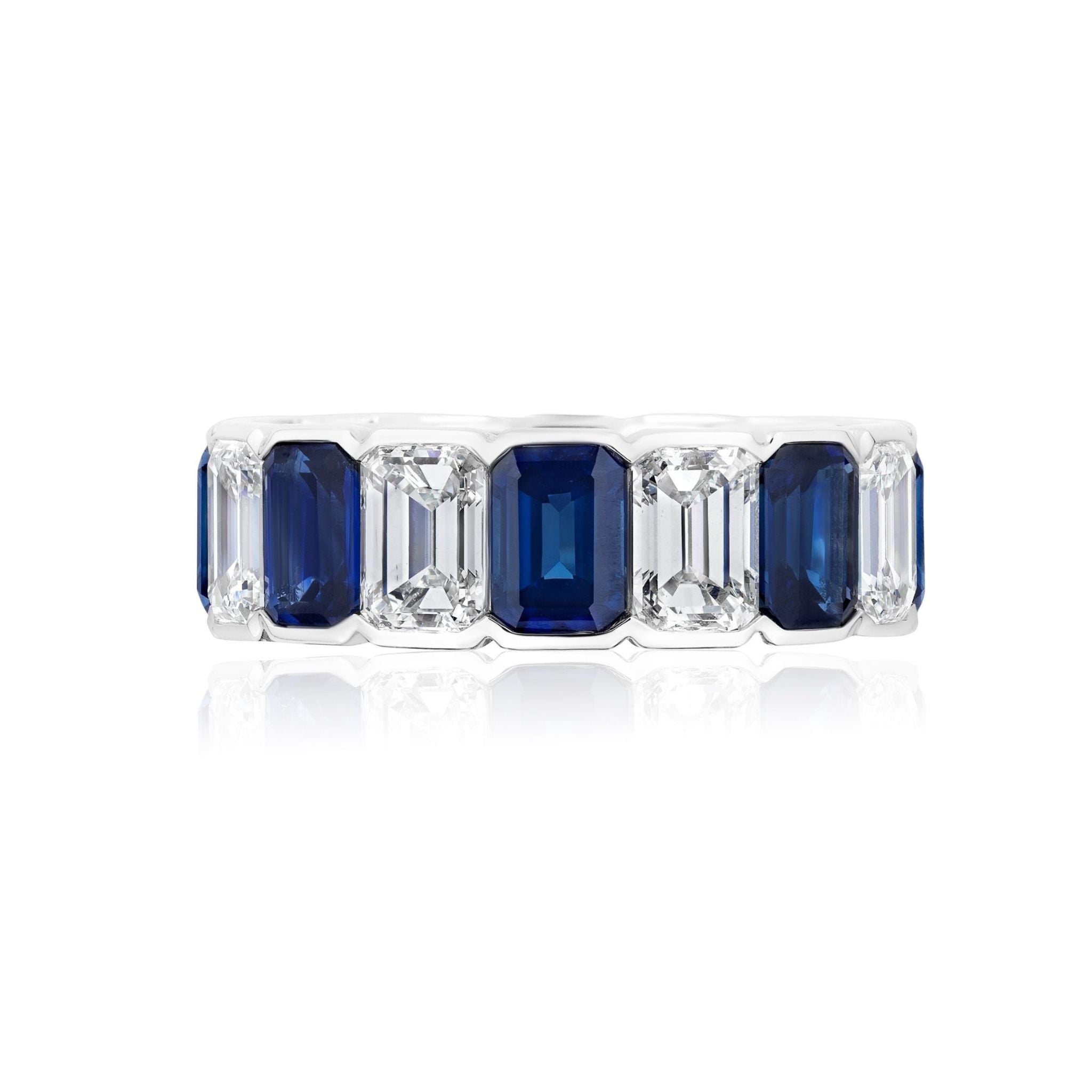 Alternating Half-Bezel Emerald Cut Diamond and Sapphire Eternity Band in platinum, displayed on a white background with a subtle reflection.