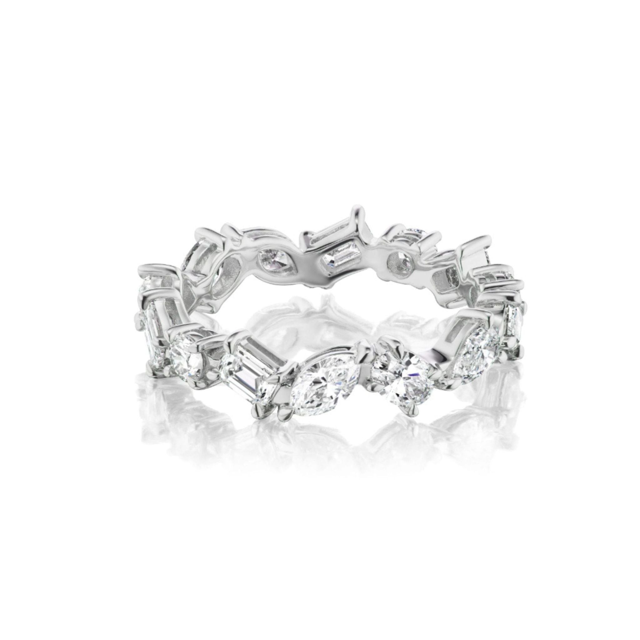 Presenting the Mixed Shape Diamond Eternity Band: a platinum ring featuring alternating round, marquise, and baguette-cut diamonds set in an endless circle, elegantly displayed on a white reflective surface—a timeless favorite among bridal rings.