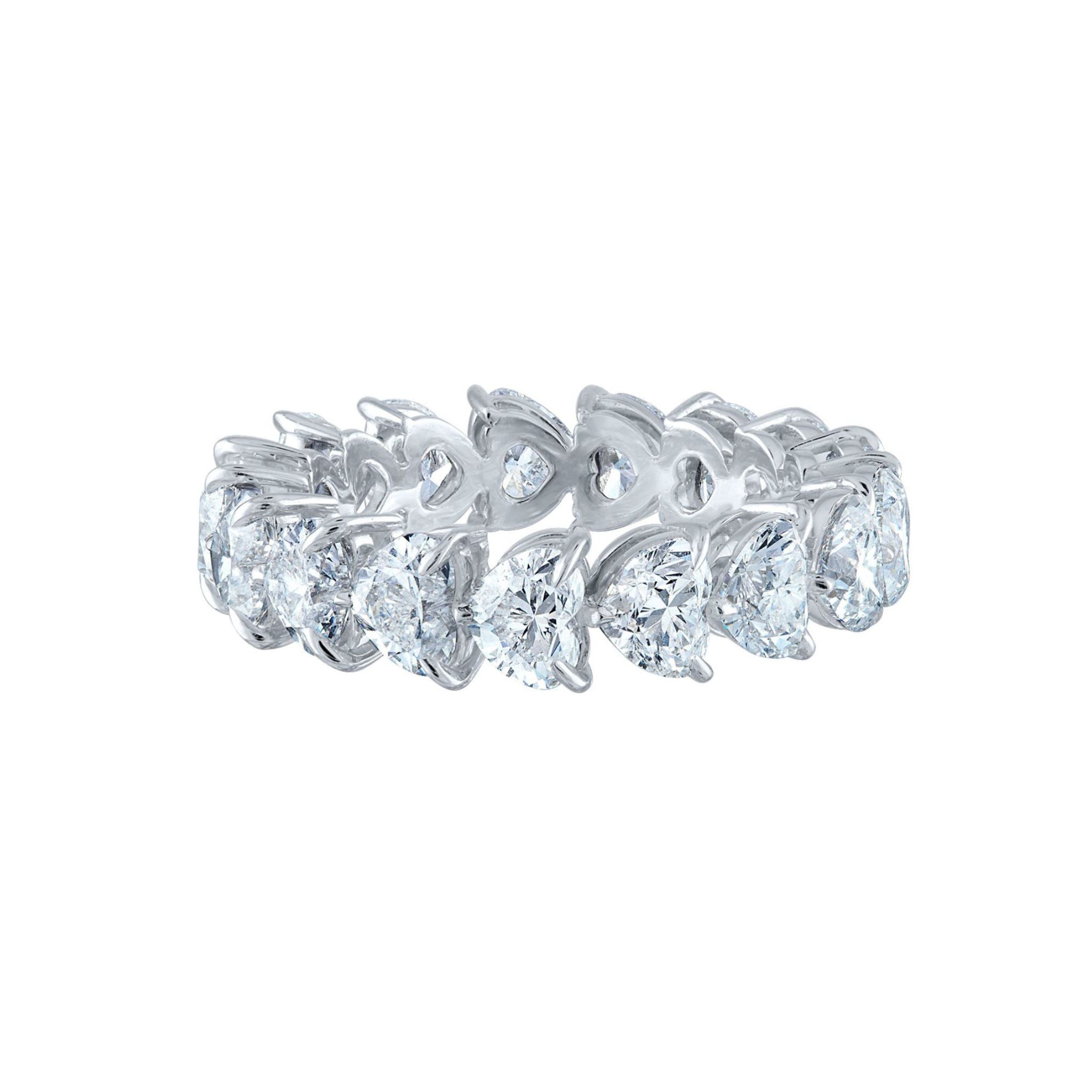 Introducing the Chasing Hearts Eternity Band—a stunning silver ring adorned with a continuous design of pear-shaped diamonds set in intricate prongs, each stone boasting SI1 clarity for enhanced brilliance, creating a sparkling and elegant loop around the band.