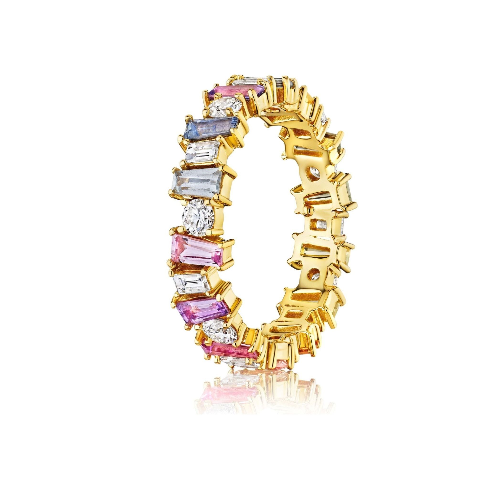 Introducing the Multicolor Eternity Band in Yellow Gold, beautifully adorned with tapered baguette sapphires and round diamonds set in a continuous row of 18k yellow gold. This elegant ring is showcased against a crisp white background.