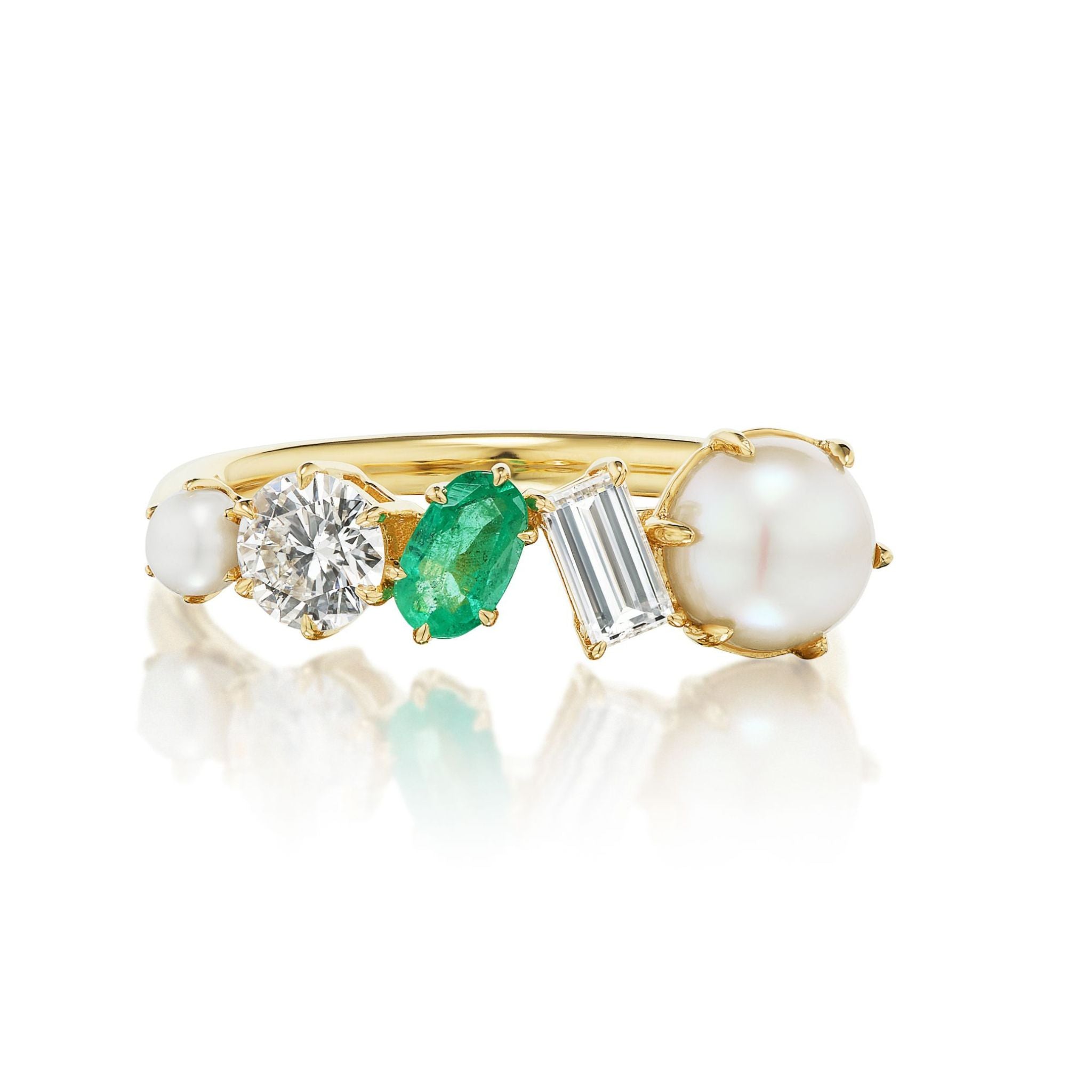 The Mixed Shape Pearl, Diamond and Emerald Half-Eternity Band features a striking sequence of a pearl, diamond, emerald, baguette-cut diamond, and petite pearl, all arranged in a row above a reflective surface.