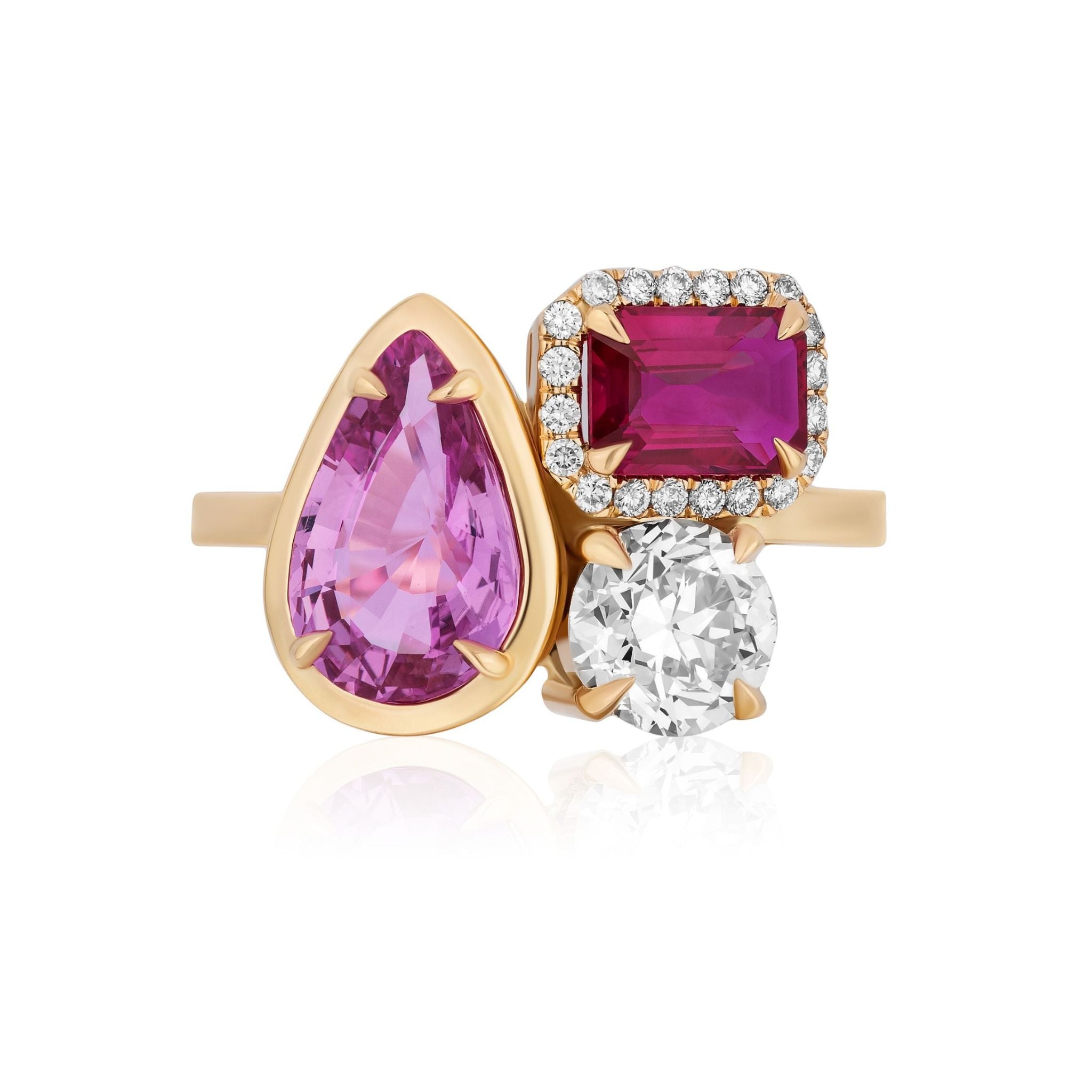 A sophisticated 18k yellow gold Cluster Ring featuring a bezel-set pear-shaped pink sapphire, pavé-set emerald cut red sapphires, and a brilliant round diamond, all accented with delicate small diamonds.