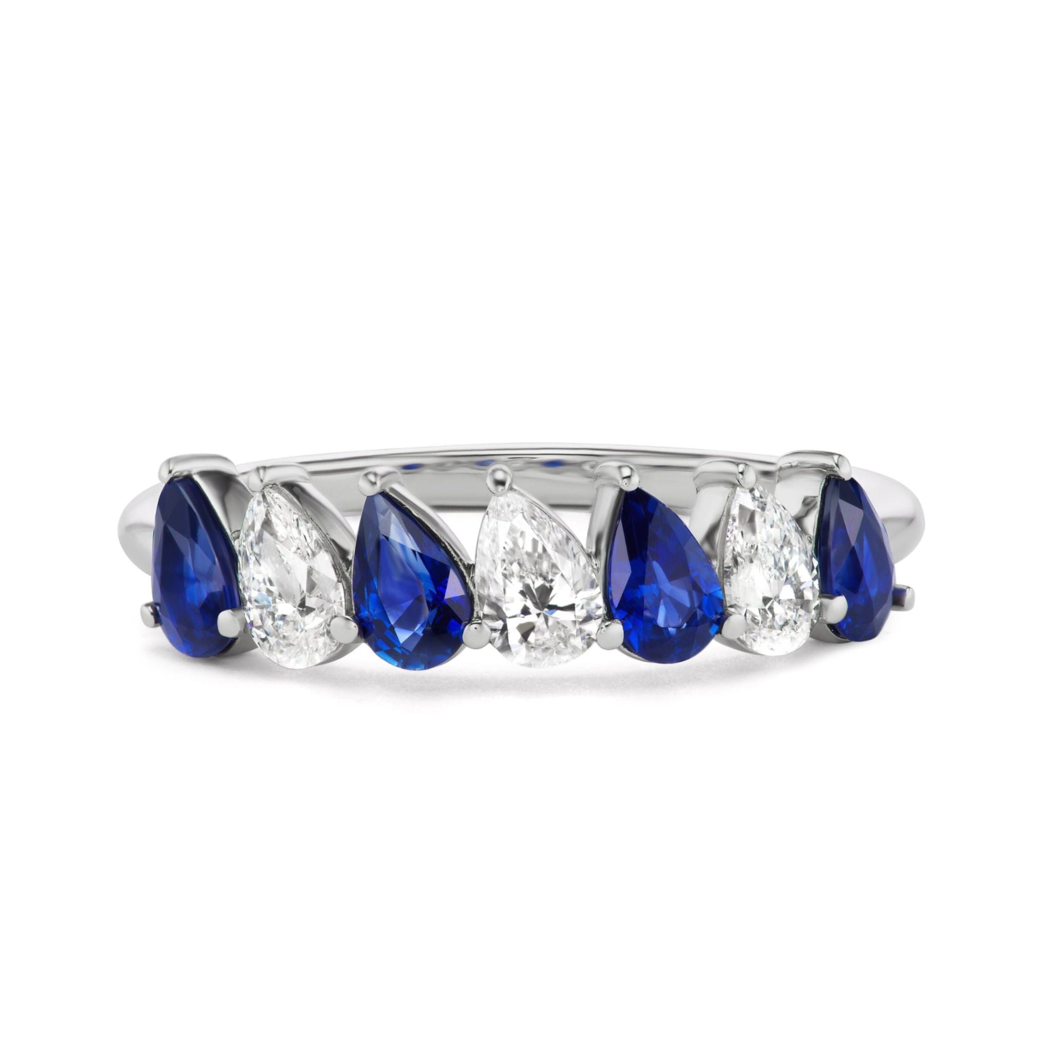 The Diagonal Pear Eternity Band features alternating pear-shaped blue sapphires and diamonds in 18K white gold, making it a perfect choice for celebration or bridal wear.