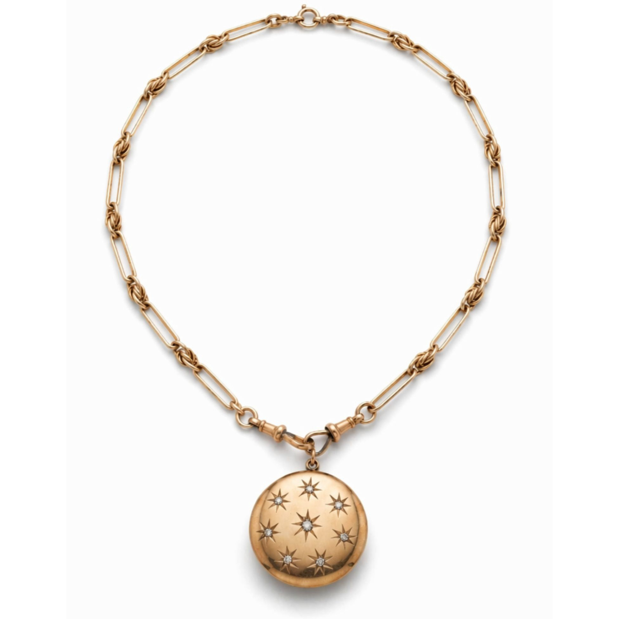 An Antique Gold Watch Chain with a Victorian locket in 14K pink gold, featuring engraved star designs and an old-cut diamond, displayed on a plain white background—a timeless piece of antique jewelry.