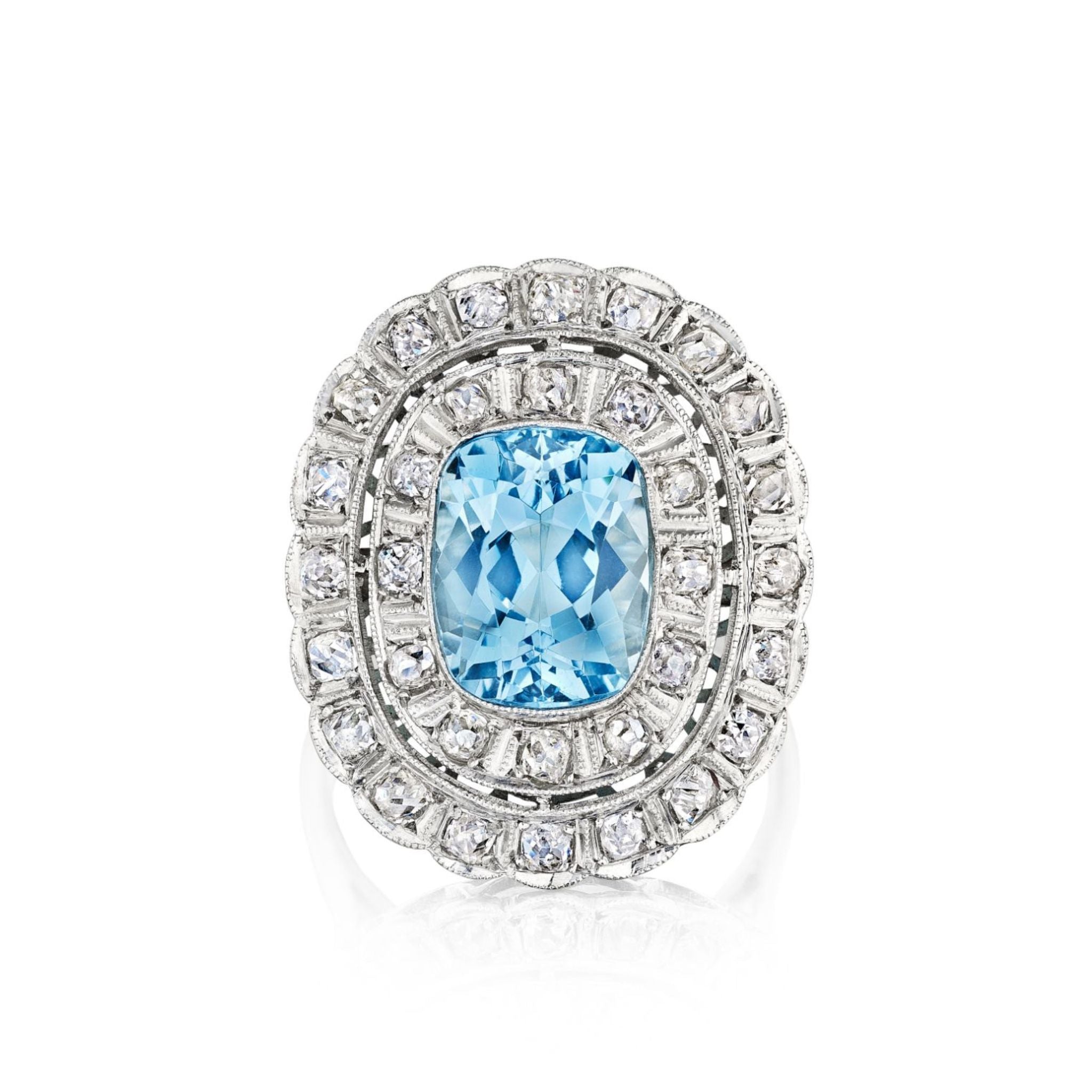 The Aquamarine and Diamond Ring features a large faceted oval light blue gemstone flanked by two rows of rose-cut diamonds, set in a platinum 1910s-inspired white metal band.