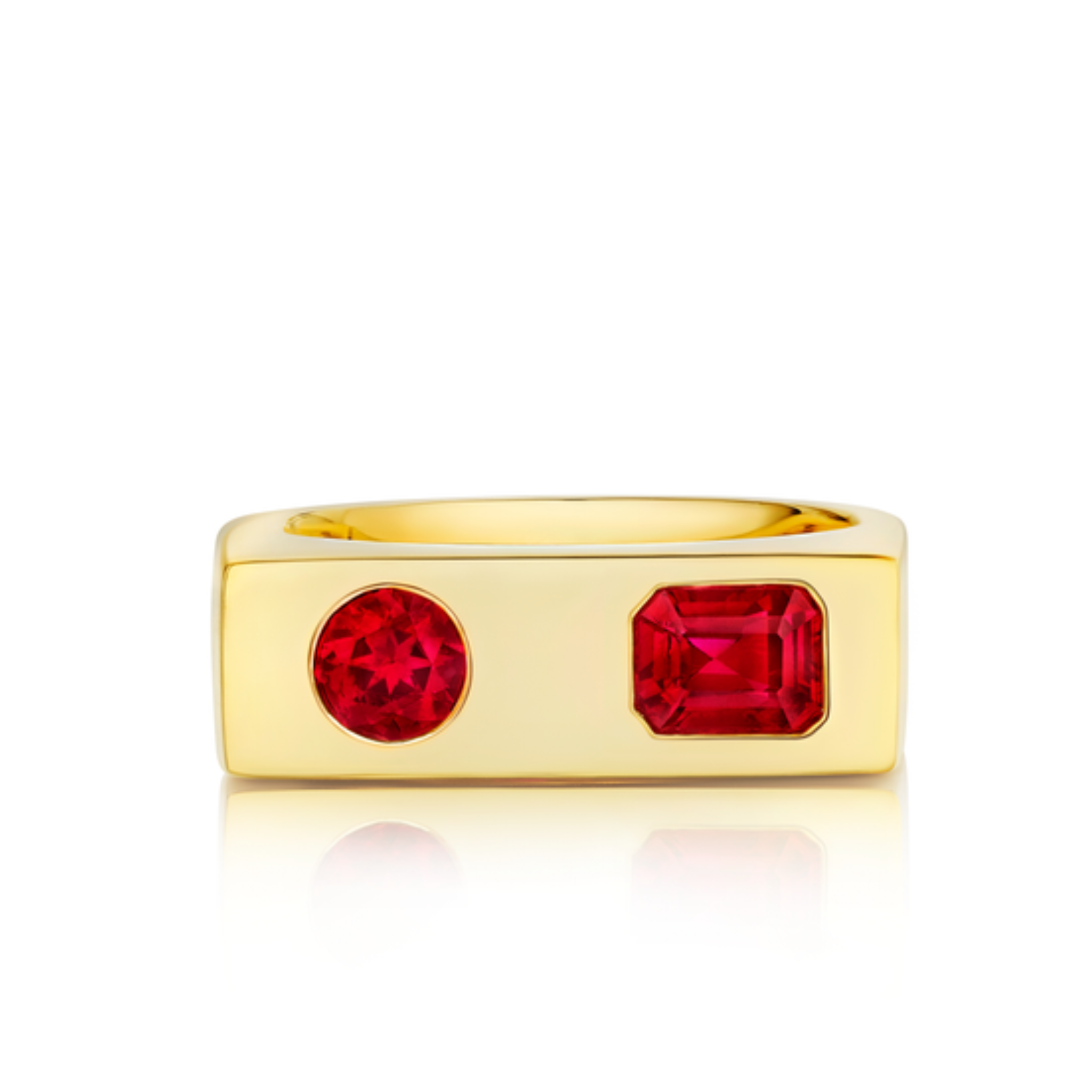 The Mixed Shape Ruby Bar Ring in Yellow Gold features a flat rectangular band with two side-by-side rubies—one round and one emerald-cut—set on the front, combining modern style with vibrant red gemstones.