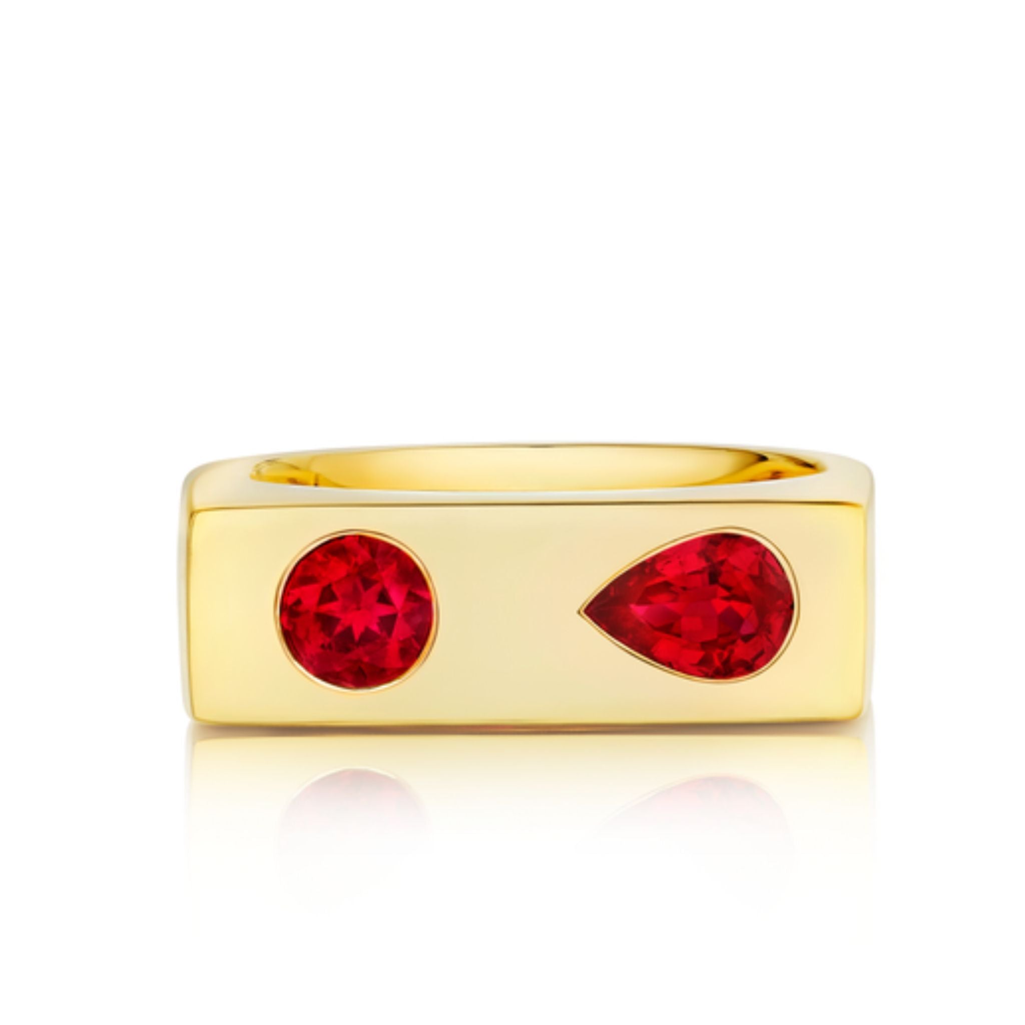 The Mixed Shape Ruby Bar Ring in Yellow Gold showcases a wide, rectangular band set with two striking pear cut rubies—one round and one teardrop-shaped—placed side by side on the front.