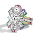 The Cross Motif Ring Jacket in white gold features round and emerald cut diamonds, a rainbow sapphire pavé halo and band, creating a vibrant, dazzling look.