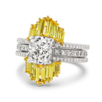 The Yellow Baguette Sapphire Ring Jacket features a cushion-cut clear center stone encircled by yellow baguette sapphires in yellow prongs, set on a white gold band with three rows of pavé diamonds for extra sparkle.