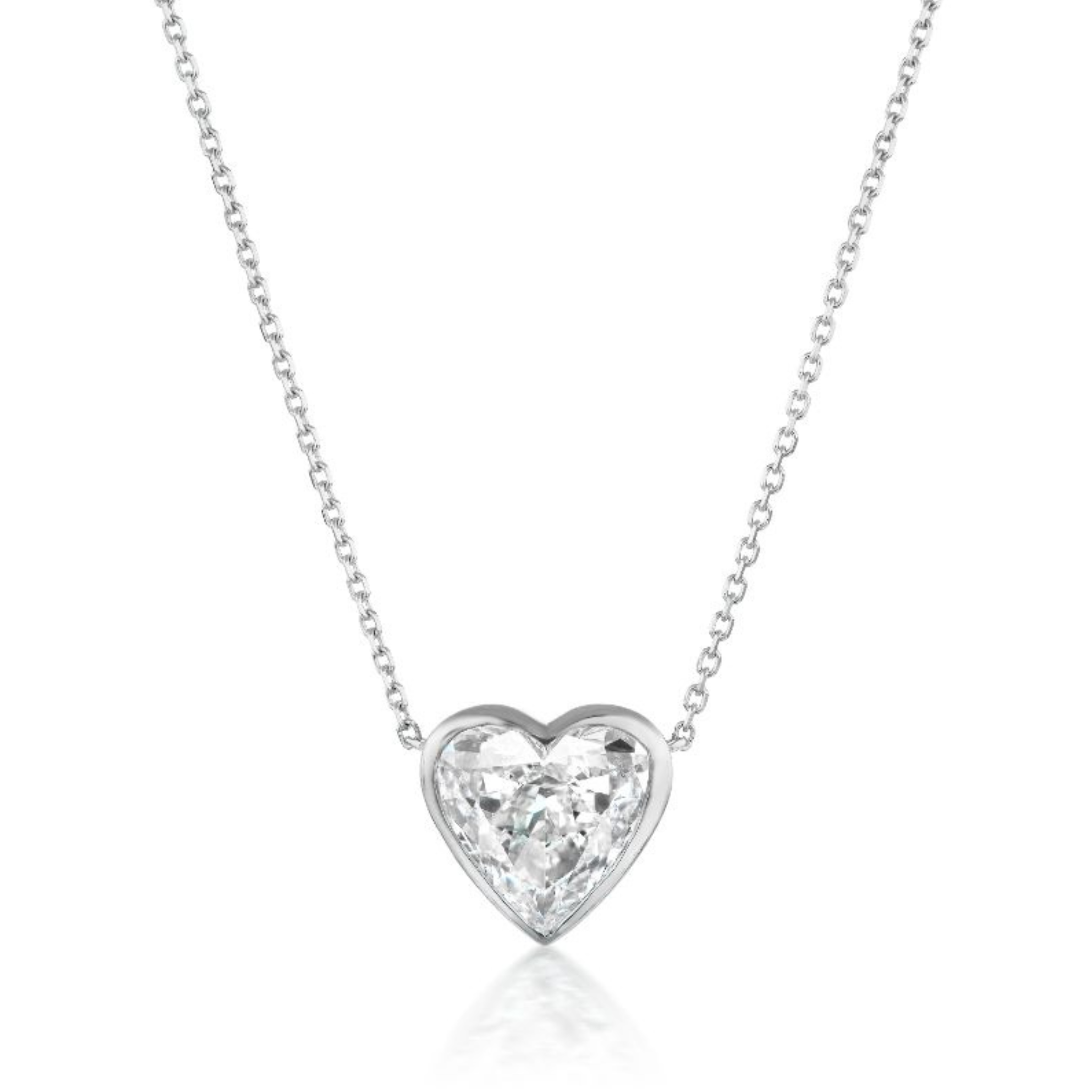 The Bezel Set Heart Diamond Solitaire Pendant in white gold features a heart-shaped diamond on a fine chain, beautifully showcased against a white background.