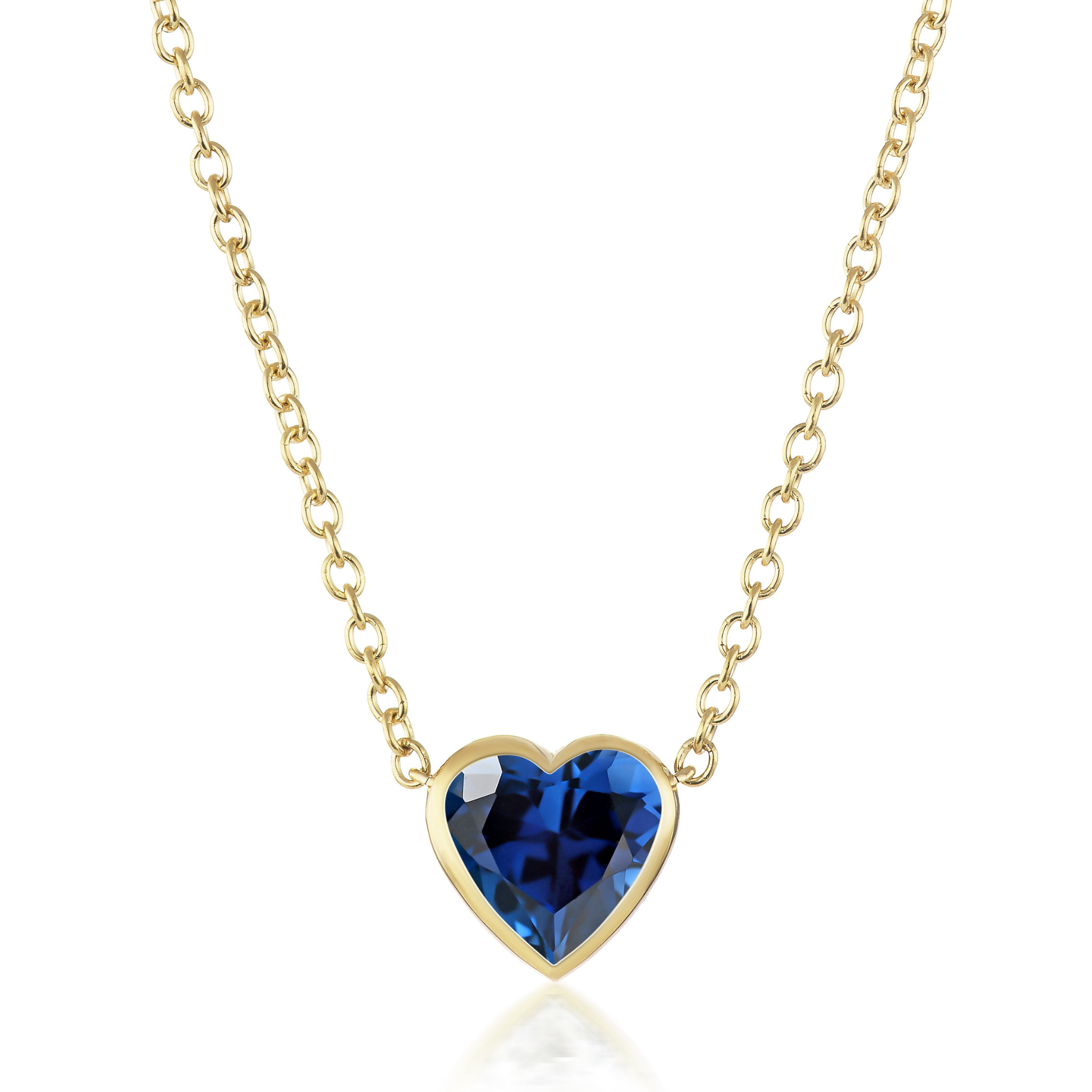 The Bezel Set Heart Shape Blue Sapphire Pendant in Yellow Gold showcases a heart-shaped blue sapphire set in 18K yellow gold, displayed against a white background.