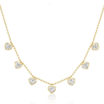 The Bezel Set Heart Shape Diamond Station Necklace features seven heart-shaped diamonds on a delicate 18k yellow gold ball chain.