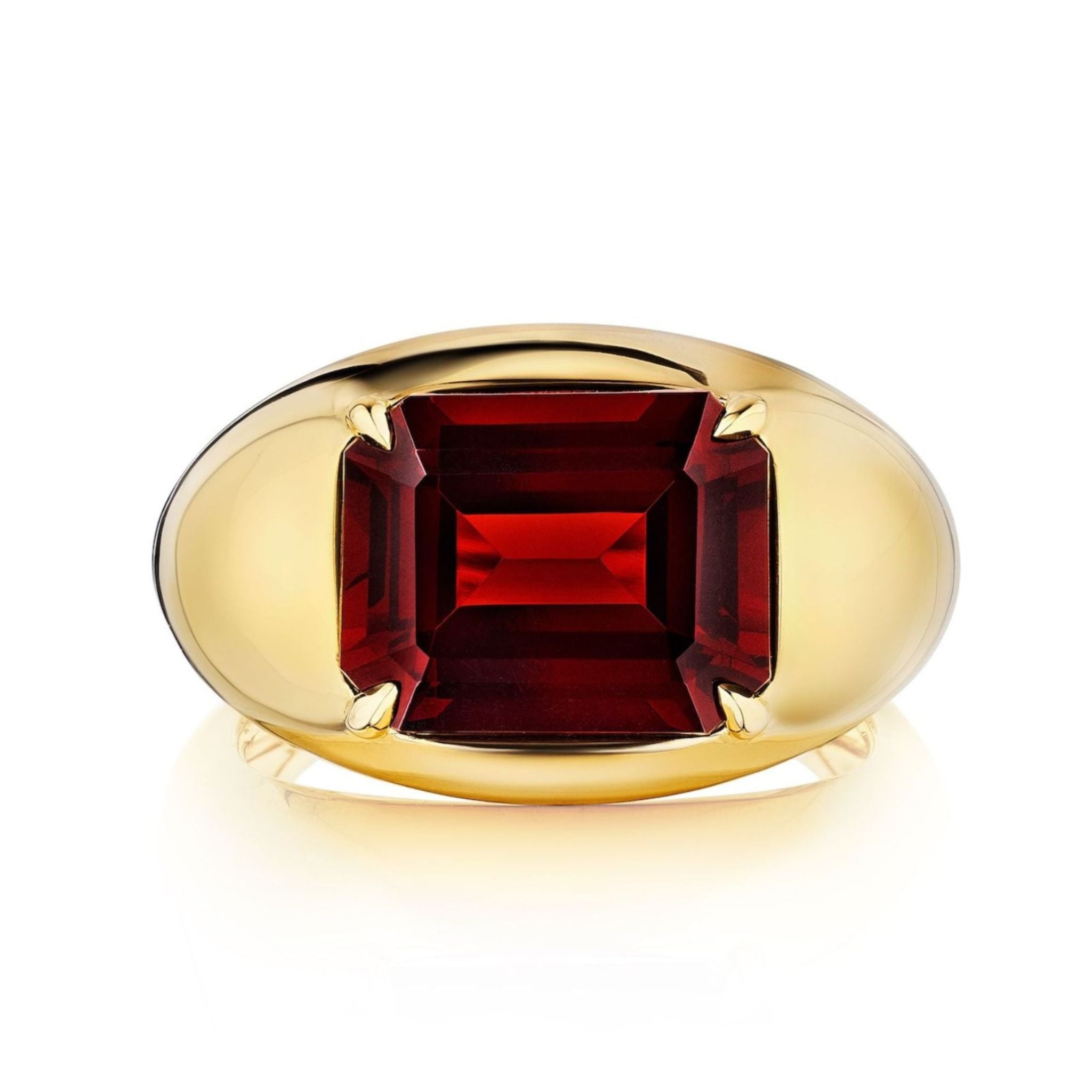 A Bombé Ring with an east-west set emerald cut ruby in yellow gold features a striking ruby mounted on a wide, smooth band.