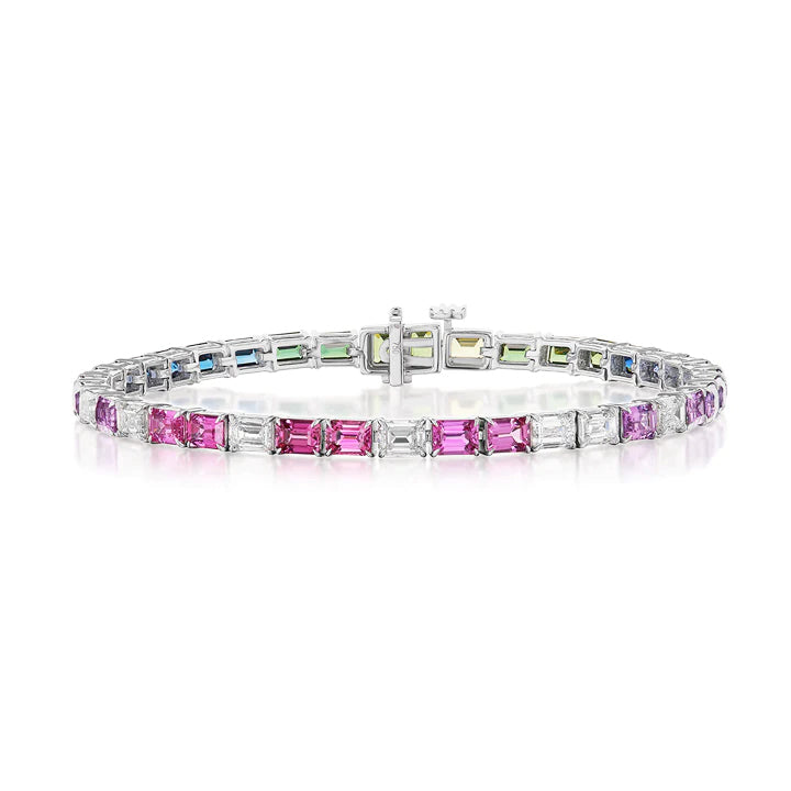 The Multicolor Emerald Cut Sapphire Tennis Bracelet features silver settings with rectangular pink, purple, green, and blue sapphires in a repeating pattern and a secure center clasp.