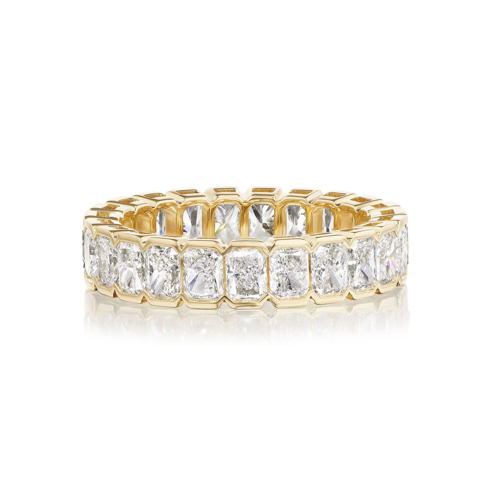 The Bracket Bezel Radiant Cut Diamond Eternity Band showcases a continuous row of radiant cut diamonds in yellow gold, beautifully presented on a white background—a stunning custom ring for special celebrations.