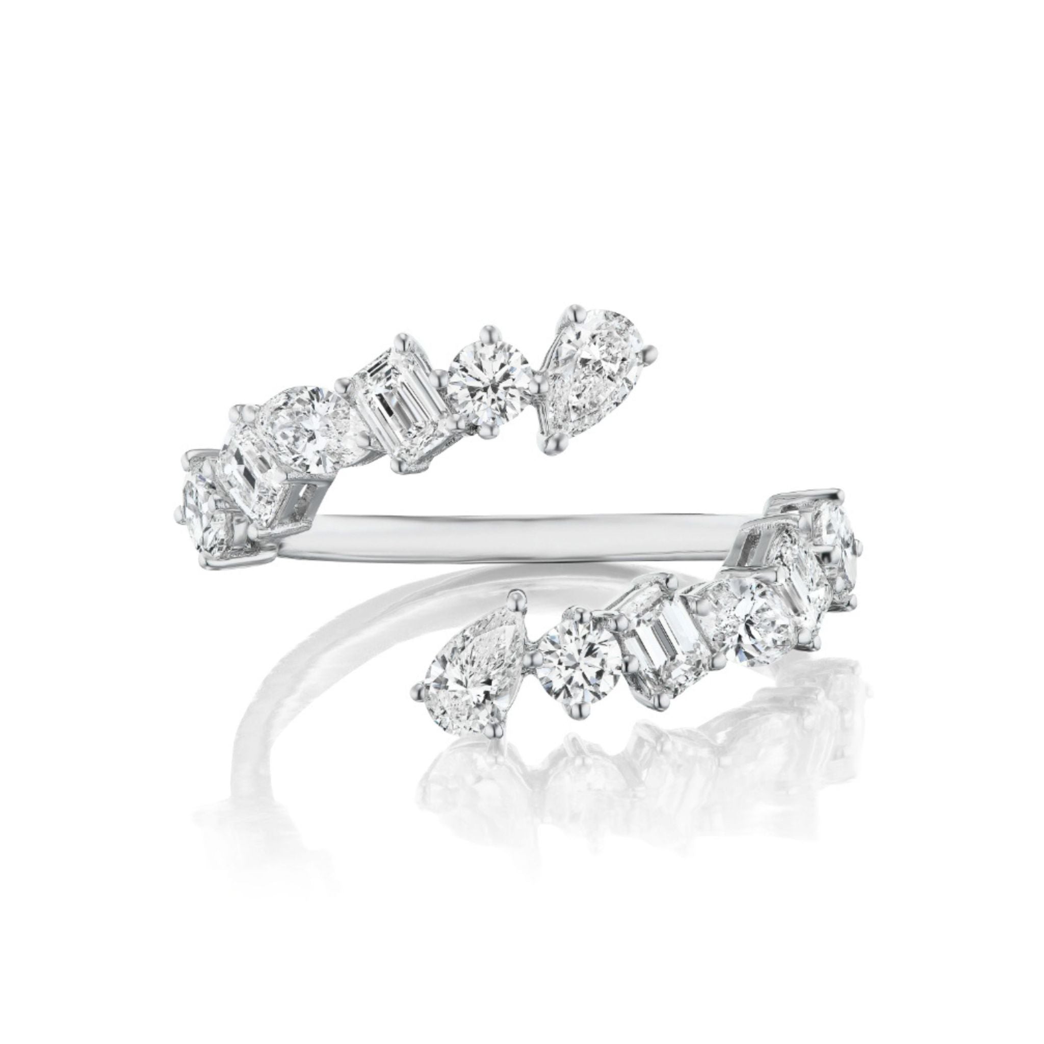 The Wraparound Ring with Mixed Shape Diamonds, featuring an open silver design set with round brilliant, emerald cut, and pear-shaped diamonds, is elegantly displayed on a reflective white surface.