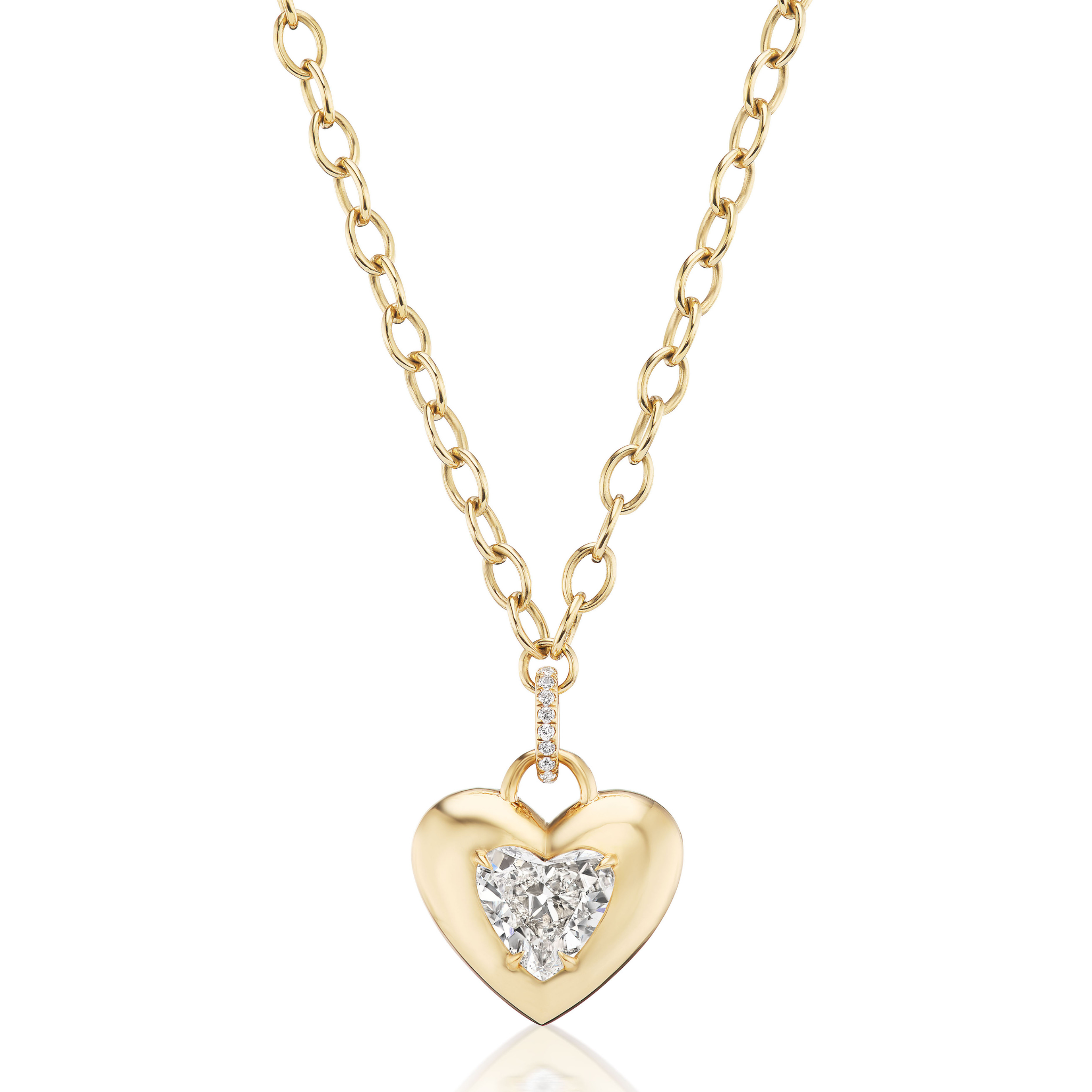 The Burnish Set Heart Shape Diamond Pendant features a polished gold heart-shaped pendant with a central heart-shaped diamond and a row of small diamonds on the loop, hanging from a gold chain necklace.