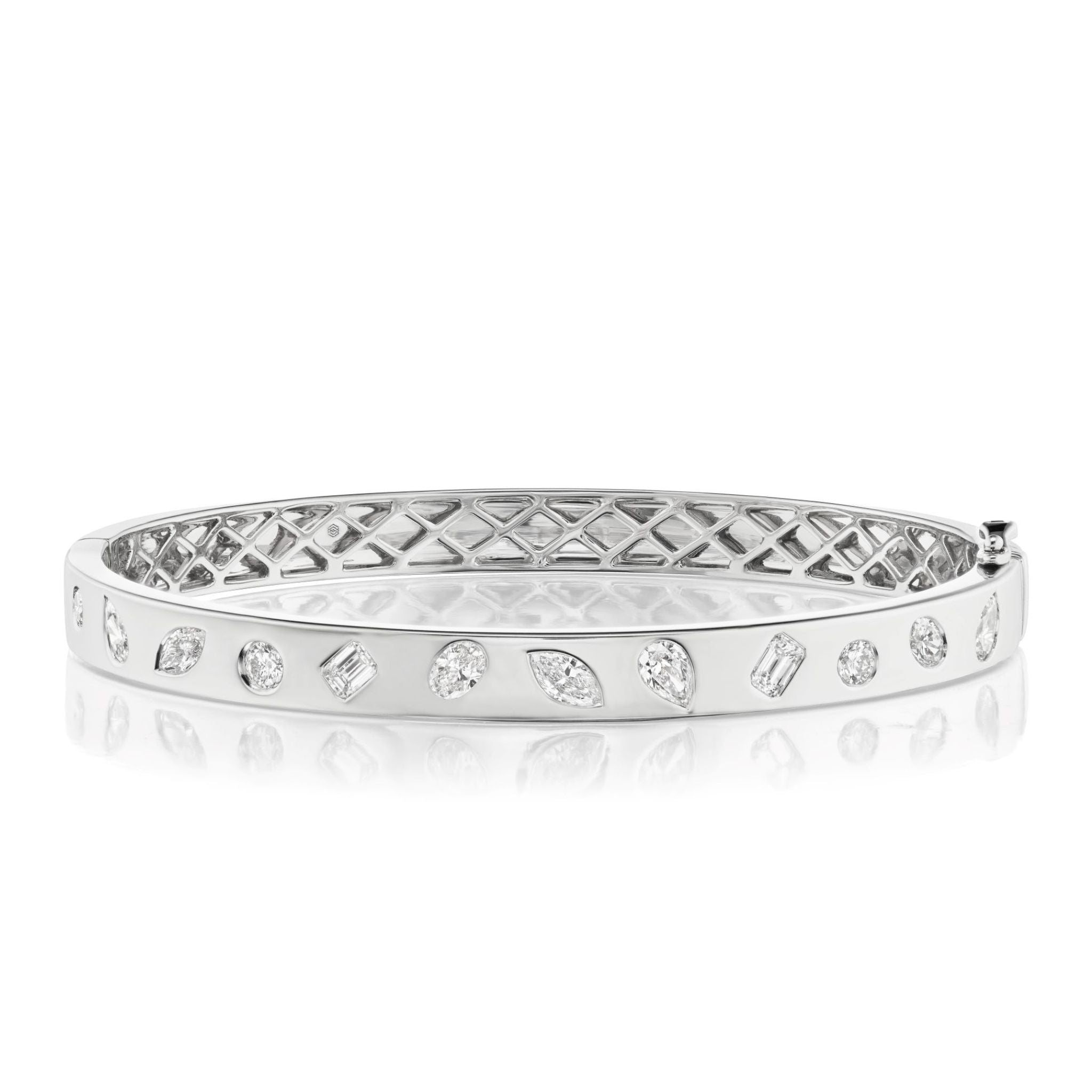 The Burnish Set Mixed Shape Diamond Bangle features mixed shape diamonds set in a random pattern around the band, with a geometric lattice design on the inner side.