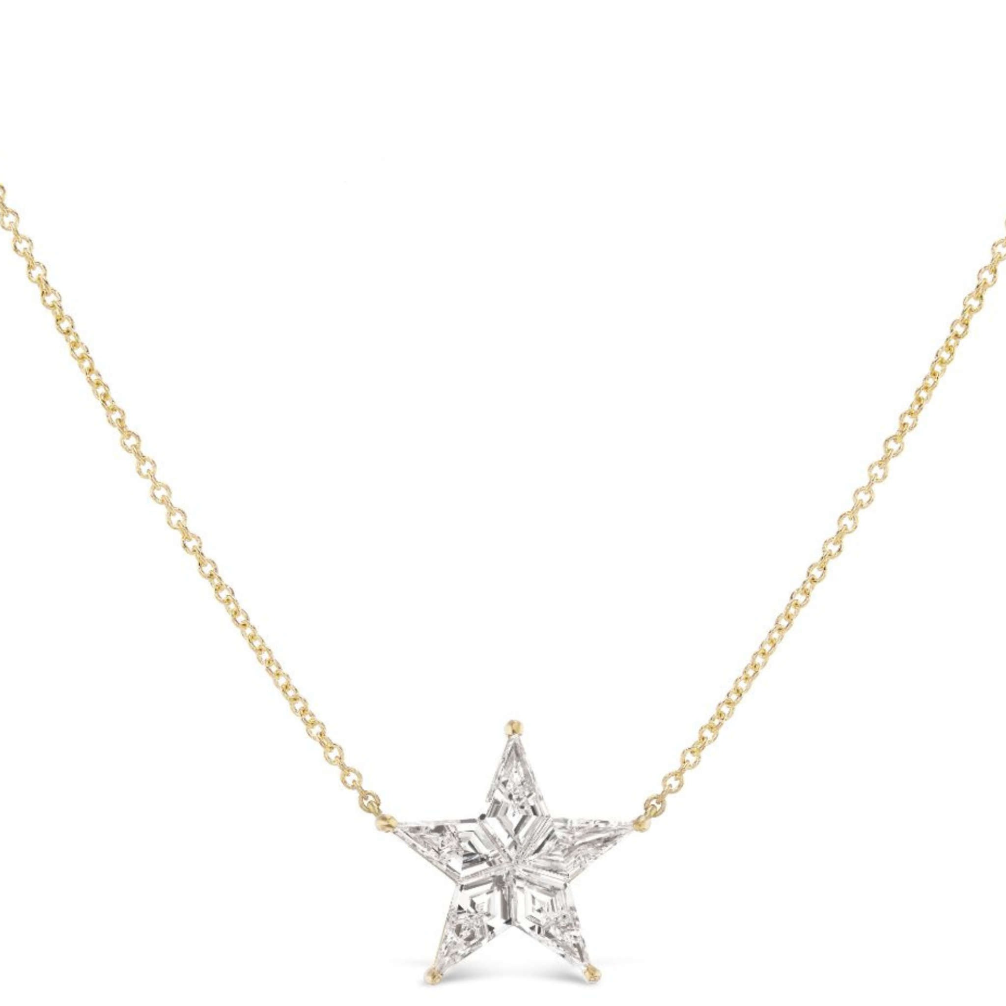 The Celestial Star Diamond Pendant is a delicate 18K gold chain necklace adorned with a sparkling star-shaped diamond crafted from clear, faceted gemstones.