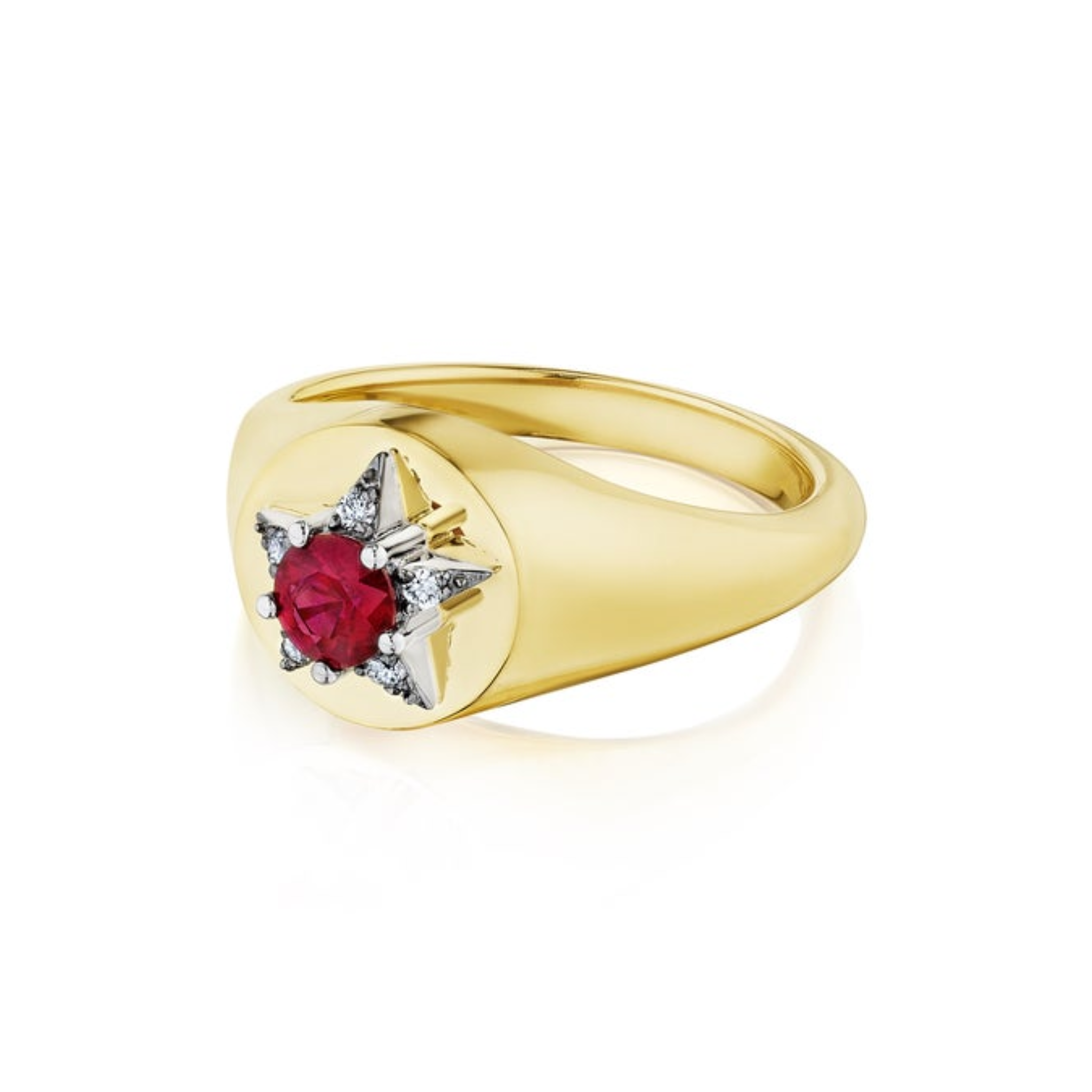 The America250 Star Signet Ring in yellow gold and platinum features a central red gemstone set in a star-shaped platinum setting accented with small diamonds, displayed on a white background.