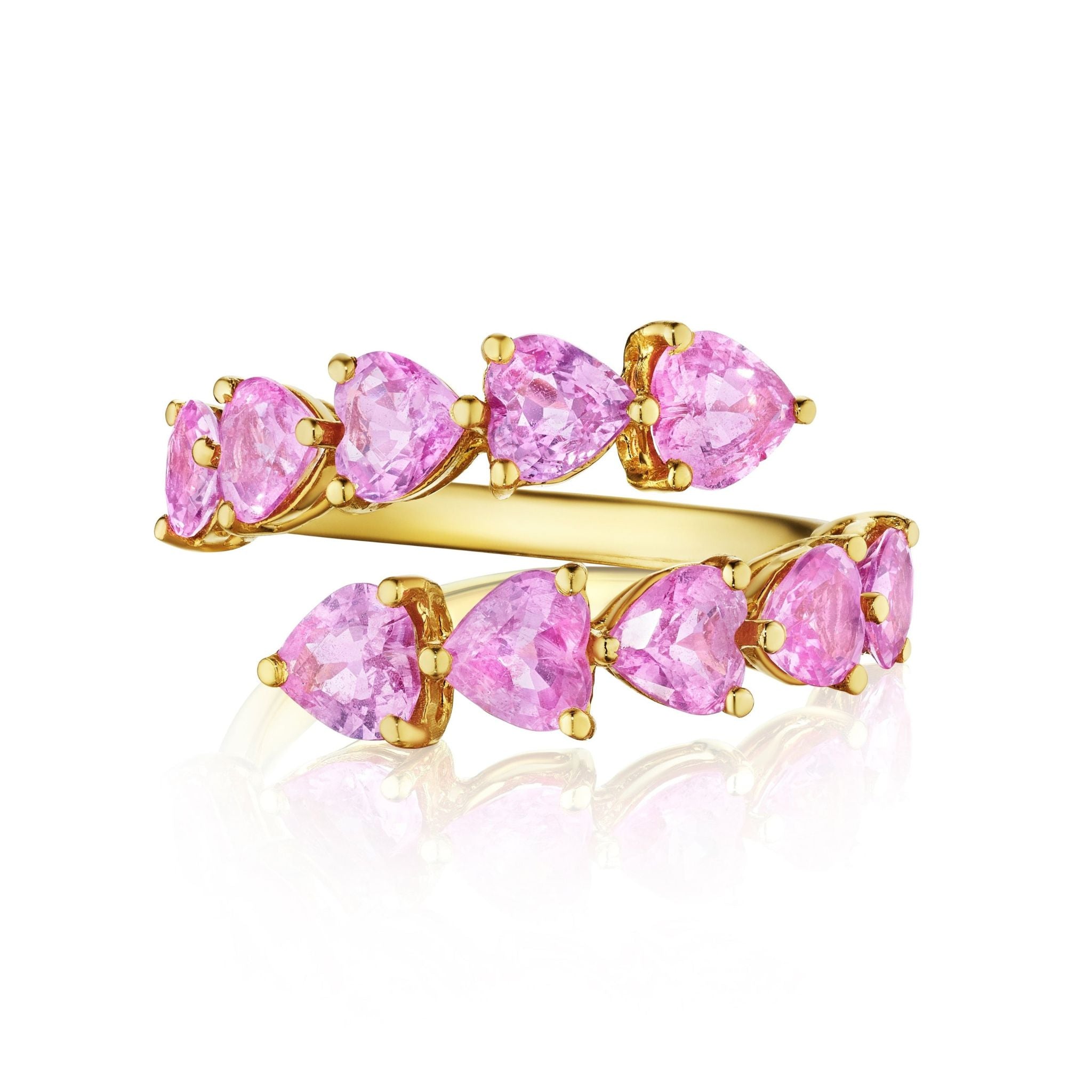 The Chasing Hearts Wraparound Ring features pear-shaped pink sapphire hearts arranged along an open band in 18K yellow gold, with prong settings that reflect light beautifully on a white background.