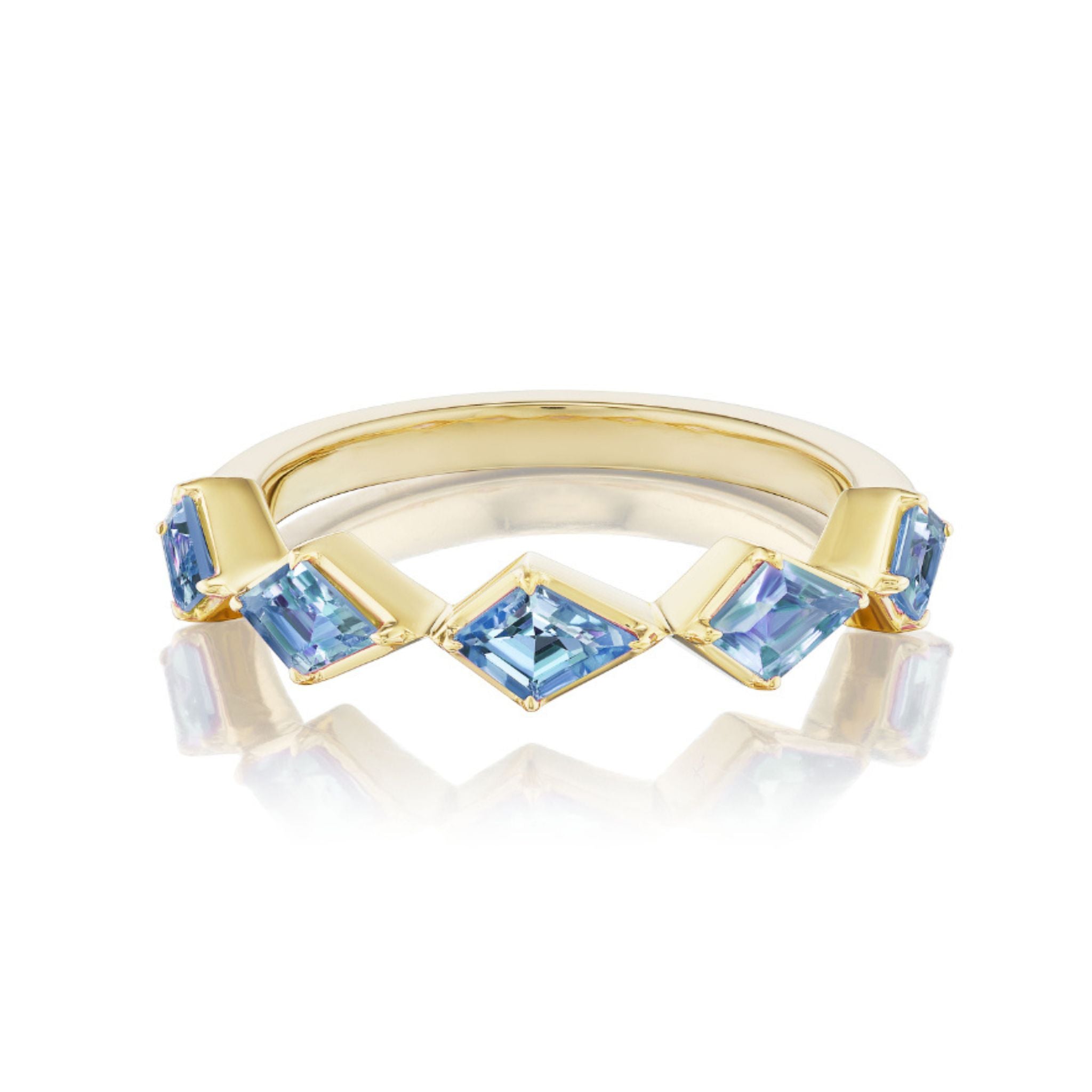 The Chasing Kites Light Blue Sapphire Half Eternity Band features five square-cut light blue sapphires in a chevron pattern, set in 18K yellow gold and photographed on a white background with a subtle reflection.