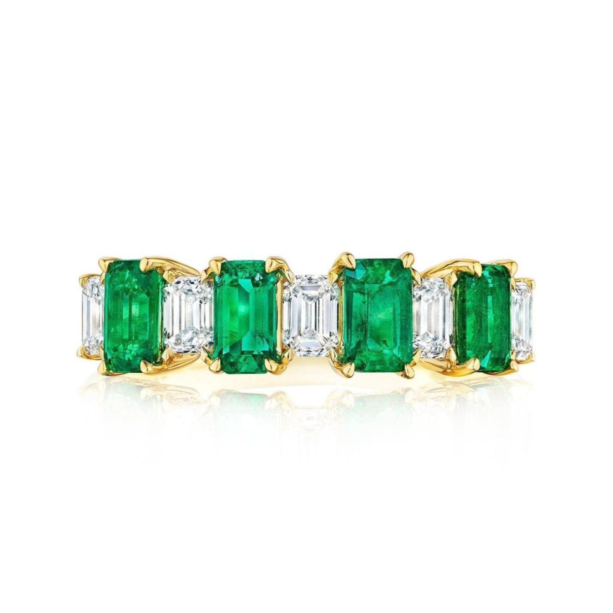 The Chroma Alternating Emerald and Diamond Half Eternity Band showcases rectangular emeralds and emerald-cut diamonds in a prong setting, crafted in 18K gold and displayed on a white background.