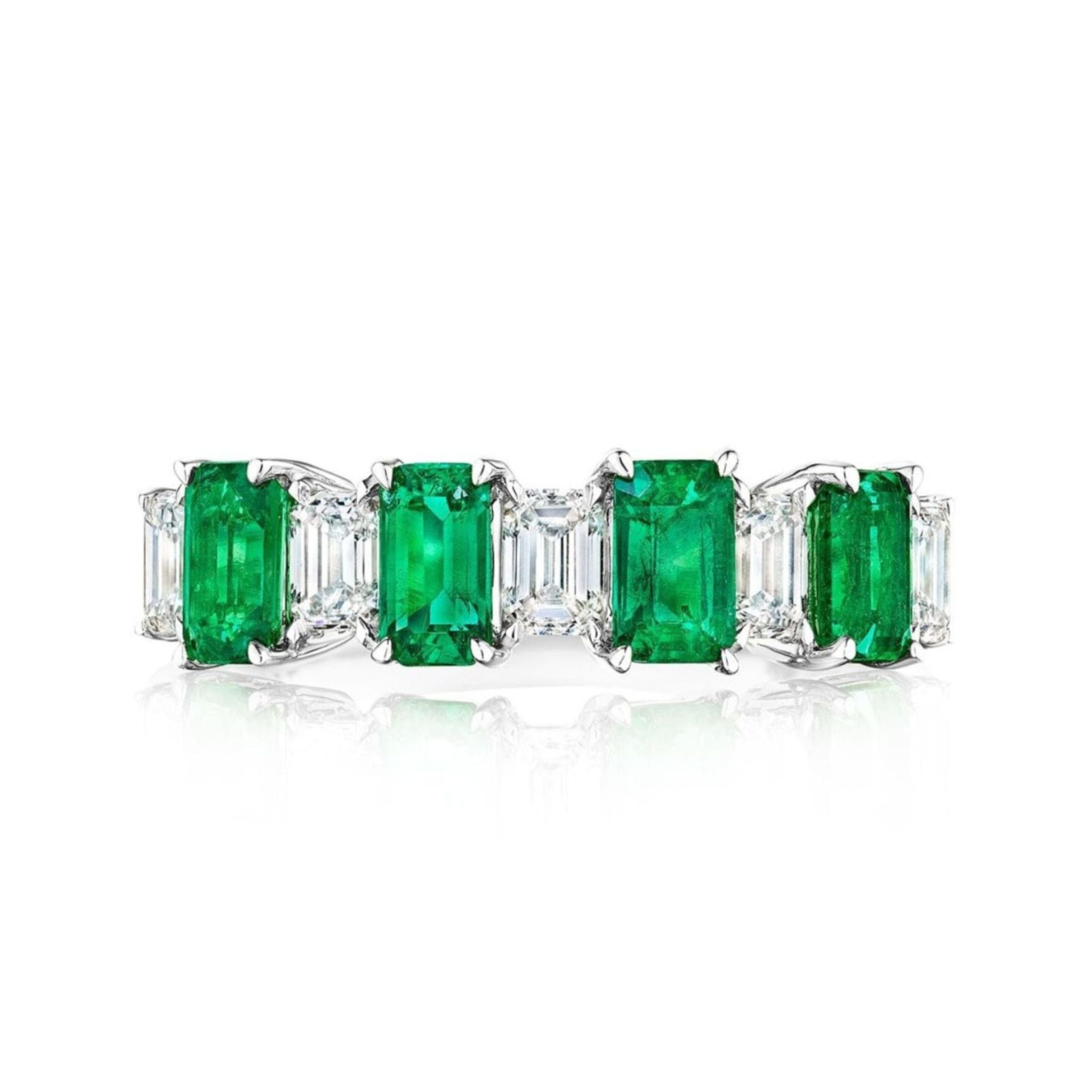 The Chroma Alternating Emerald and Diamond Half Eternity Band features rectangular green emeralds and emerald cut diamonds set in a white metal band, displayed on a white background.