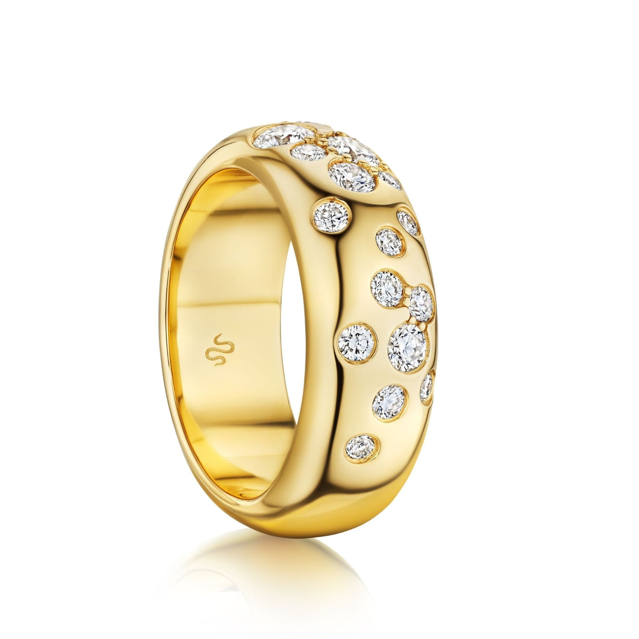 The Cluster Cigar Band with Burnish Set Round Brilliant Diamonds is a wide 18K yellow gold ring, polished and adorned with multiple round brilliant diamonds in a scattered pattern, shown on a white background.
