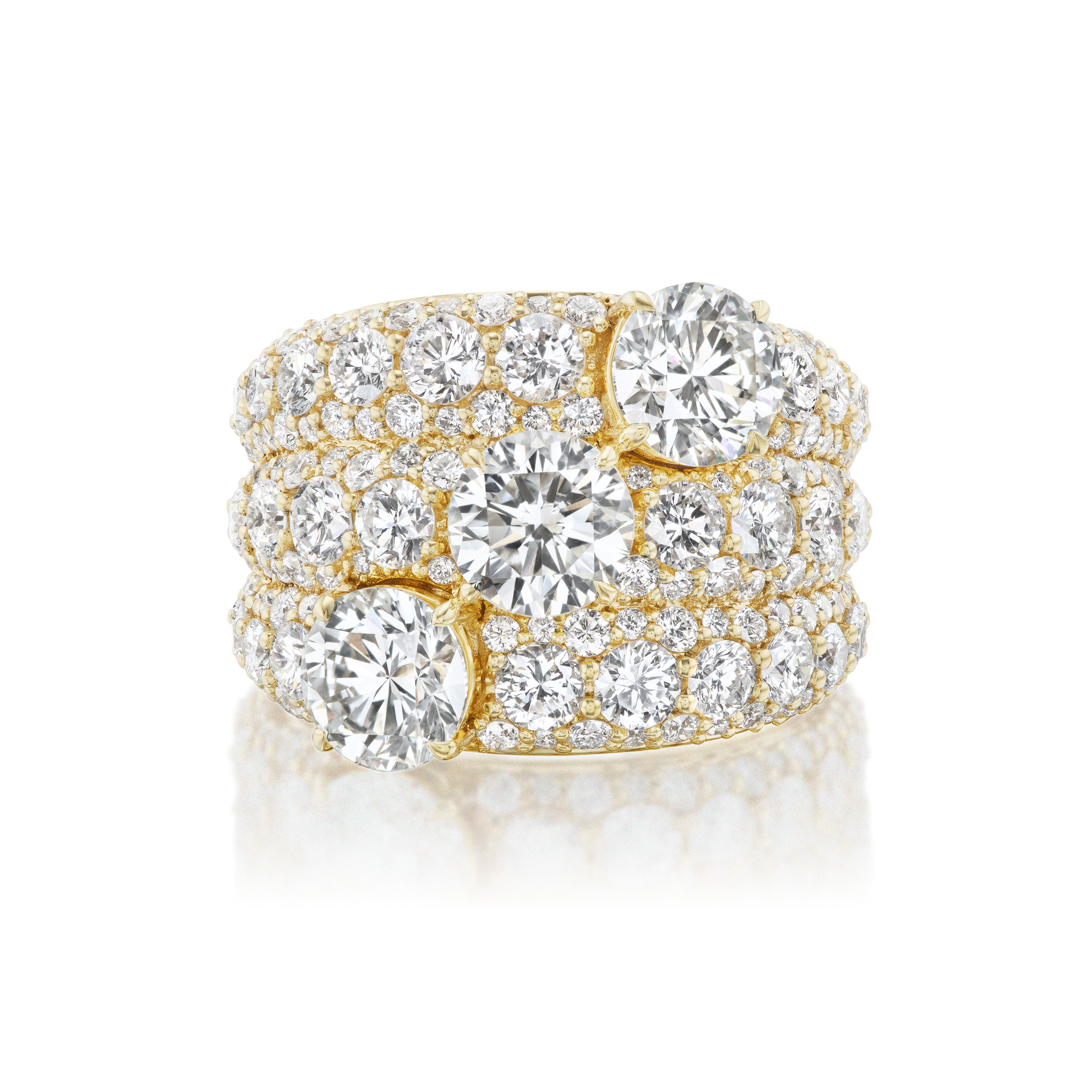 The Three Stone Round Diamond Cocktail Ring in yellow gold features multiple rows of round white diamonds and three prominent stones set across the top.