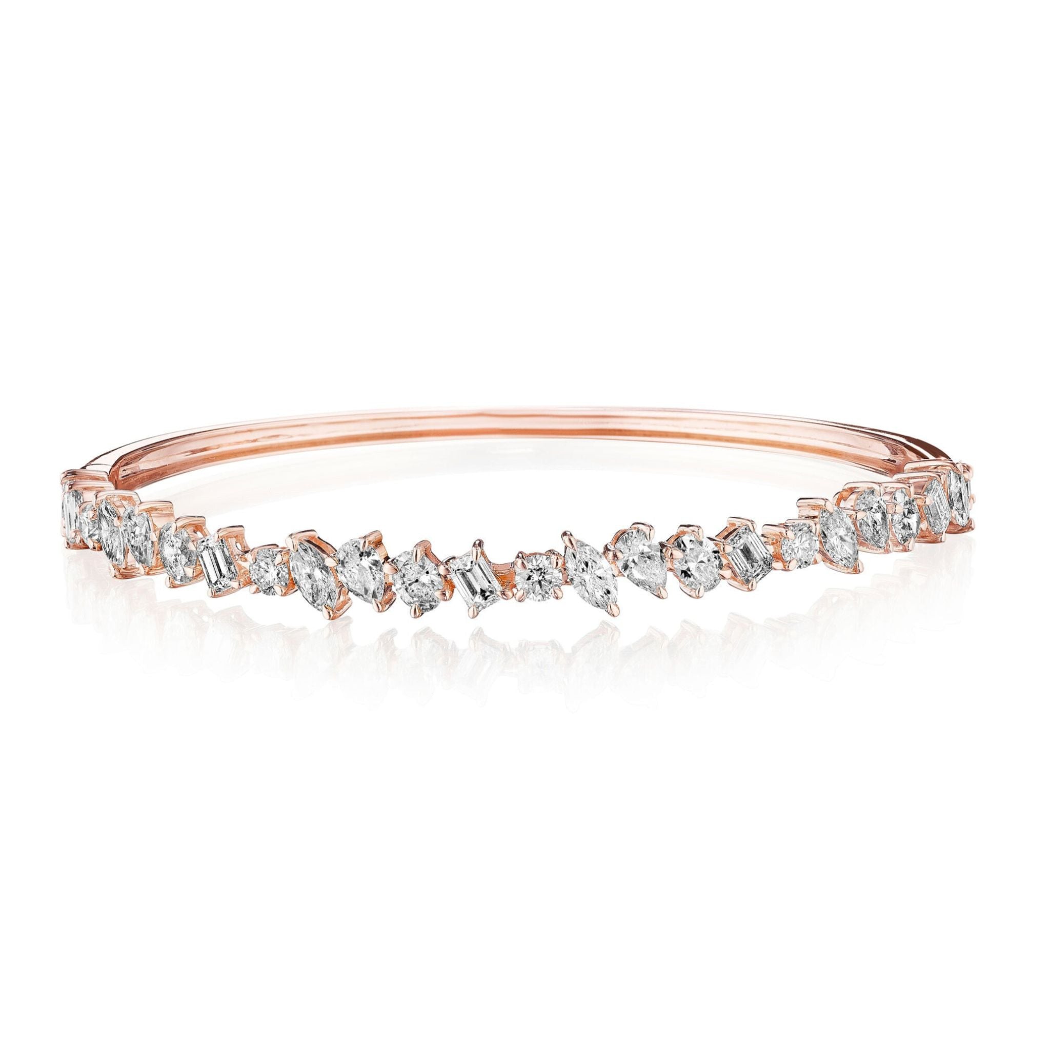 Introducing the Marching Mixed Shape Diamond Bangle: a rose gold bracelet featuring an alternating pattern of oval, round, and emerald-cut VS clarity diamonds, set in a delicate and elegant design reminiscent of an 18K gold bangle.