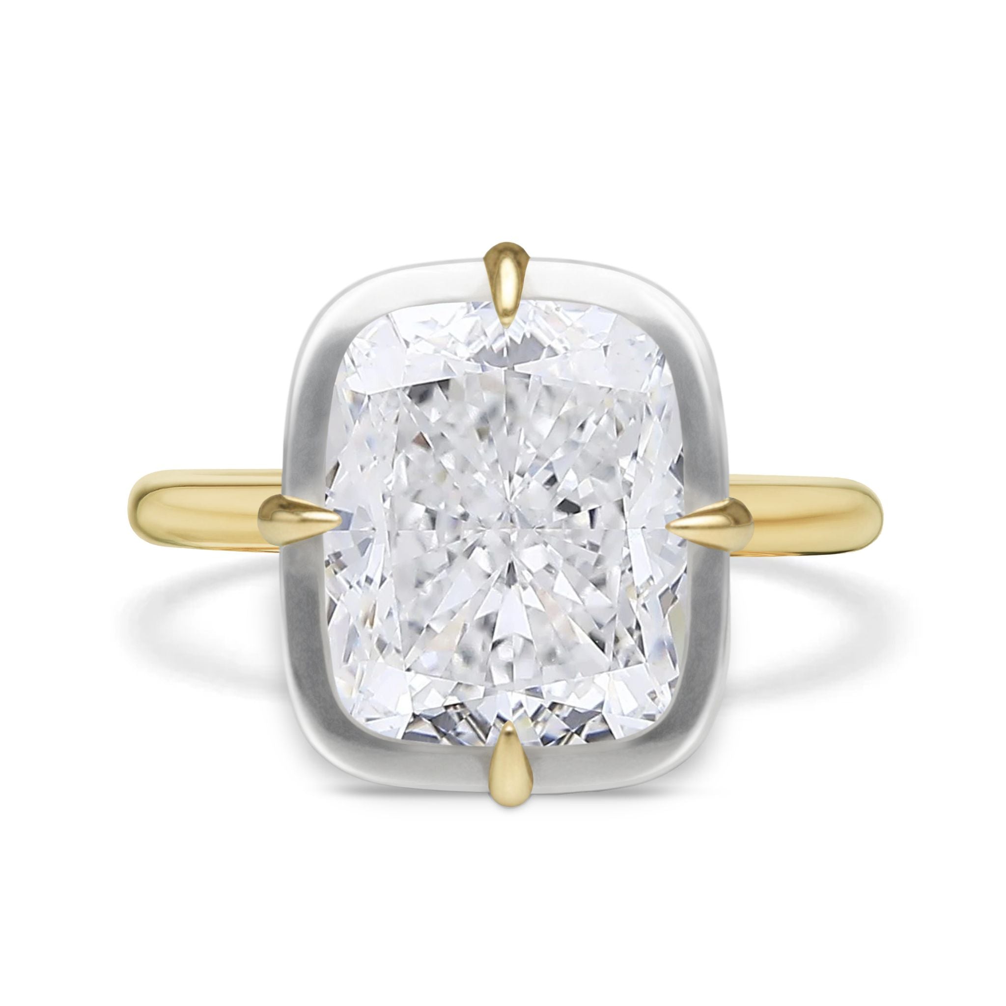 The Collet Set Cushion Cut Diamond Engagement Ring features a cushion-cut diamond in a white gold bezel with four yellow gold prongs, set on a simple yellow gold band.