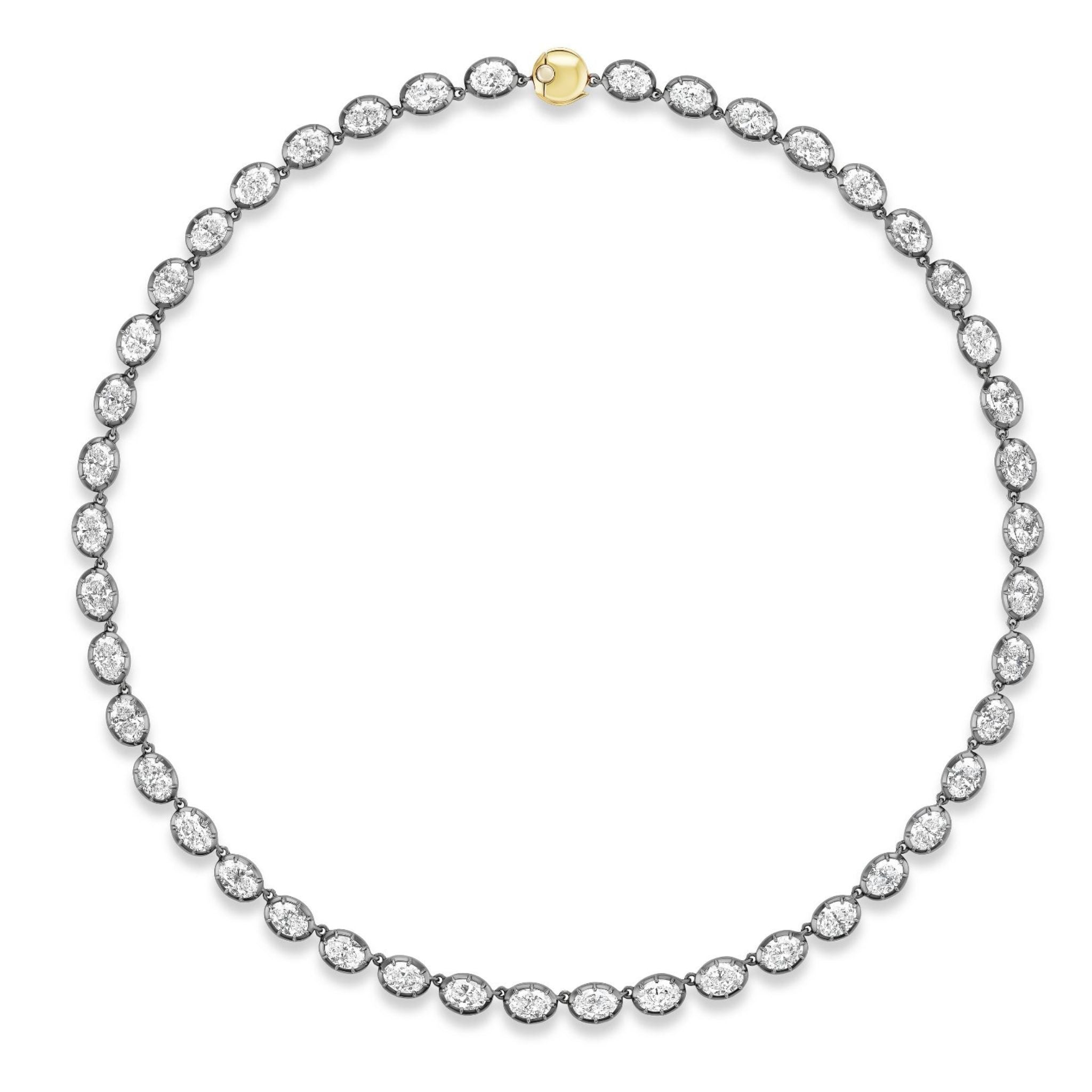 The Collet Set Oval Diamond Tennis Necklace in Black Rhodium showcases a continuous loop of oval diamonds, each gracefully set in silver-toned metal with refined black rhodium plating and highlighted by a single round 18k yellow gold clasp at the top center. Displayed against a white background.
