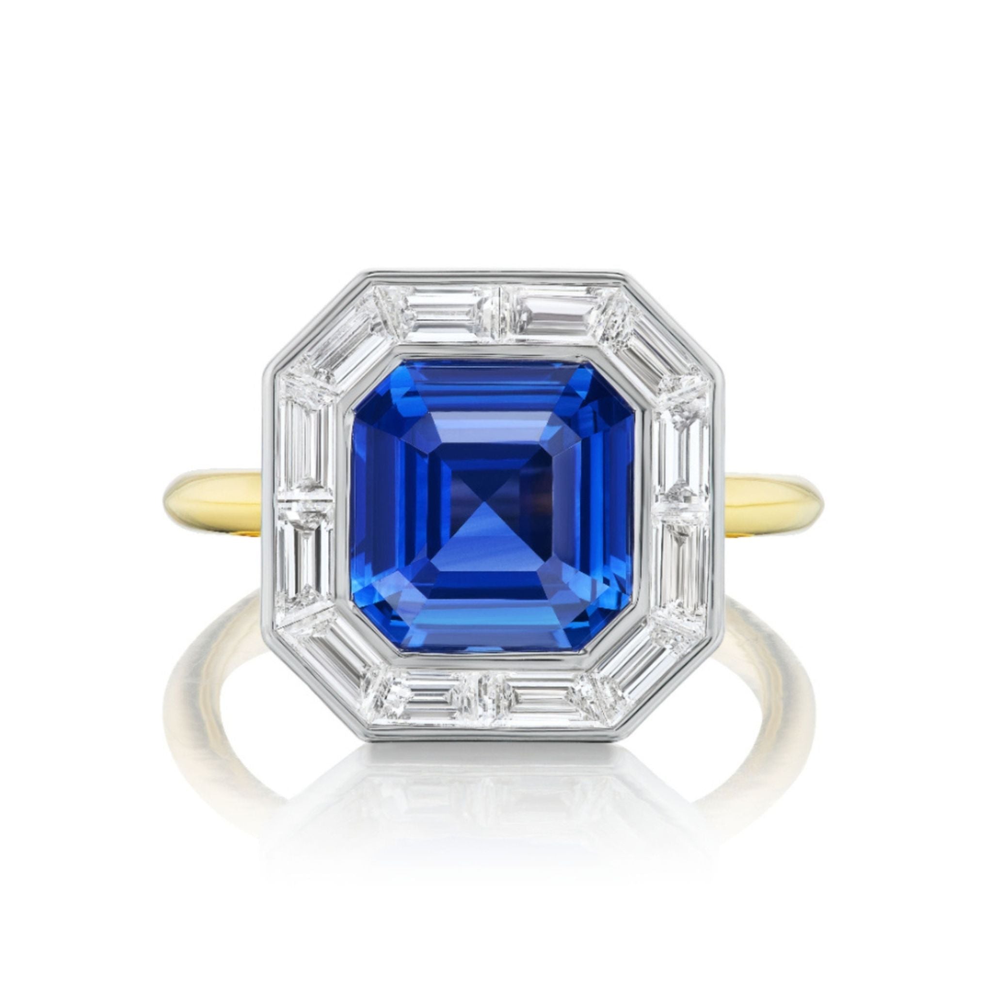 Introducing the Mosaic Ring with Asscher Cut Sapphire and Baguette Diamonds: an elegant 18k gold ring showcasing a central, Asscher cut blue sapphire, framed by baguette diamond accents in a refined geometric design.