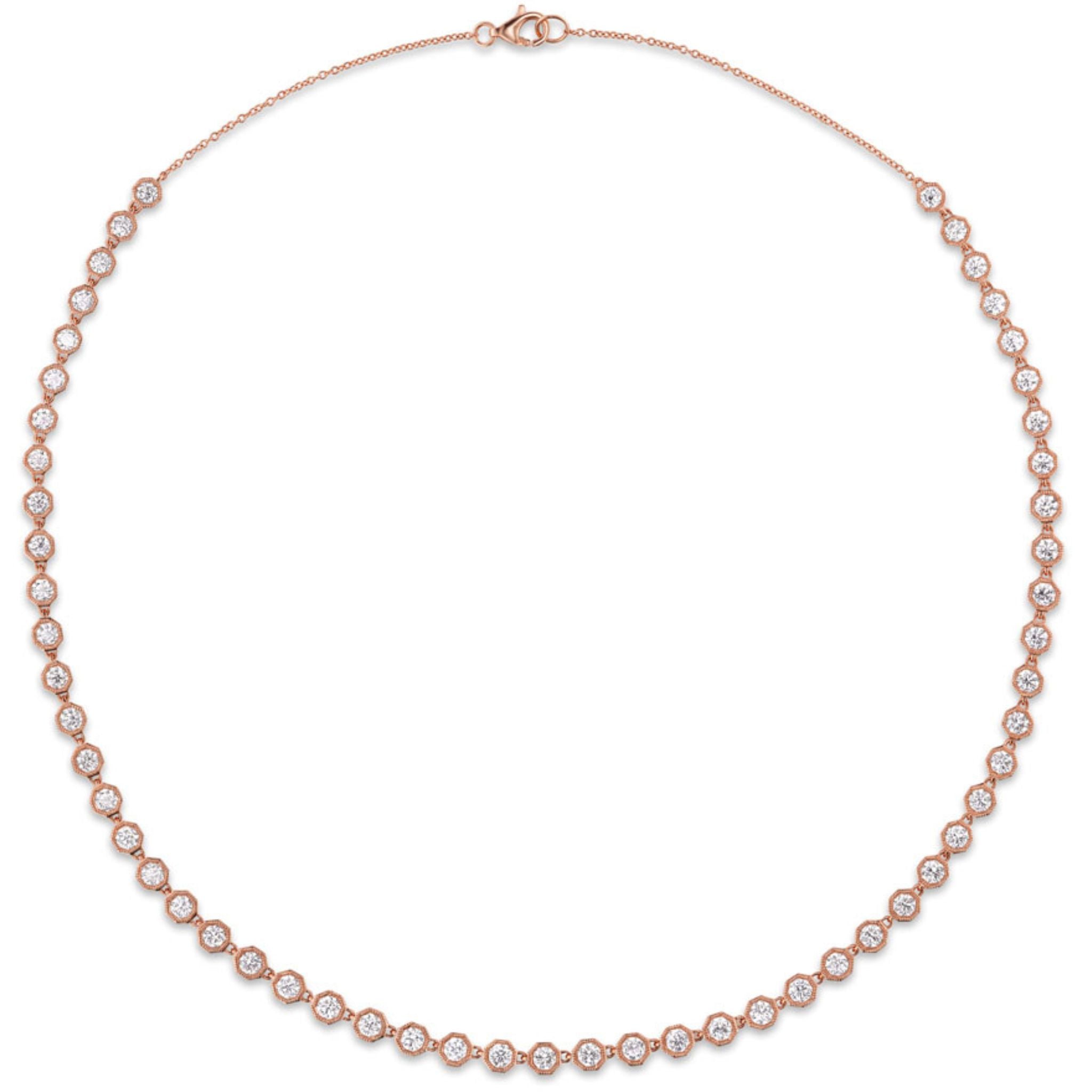 Introducing the Octagonal Bezel Set Tennis Necklace with Round Diamonds: an elegant rose gold necklace featuring evenly spaced round brilliant diamonds of SI1 clarity, each securely set in octagonal bezel settings crafted from 18k gold, and finished with a lobster clasp closure at the back.