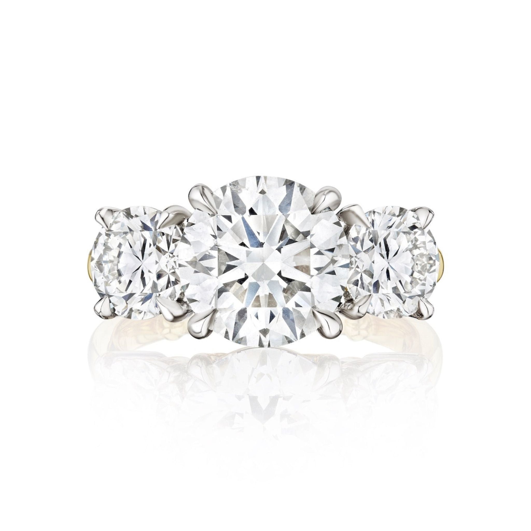 A diamond engagement ring with a round center stone and round side stones, set in polished platinum and yellow gold.