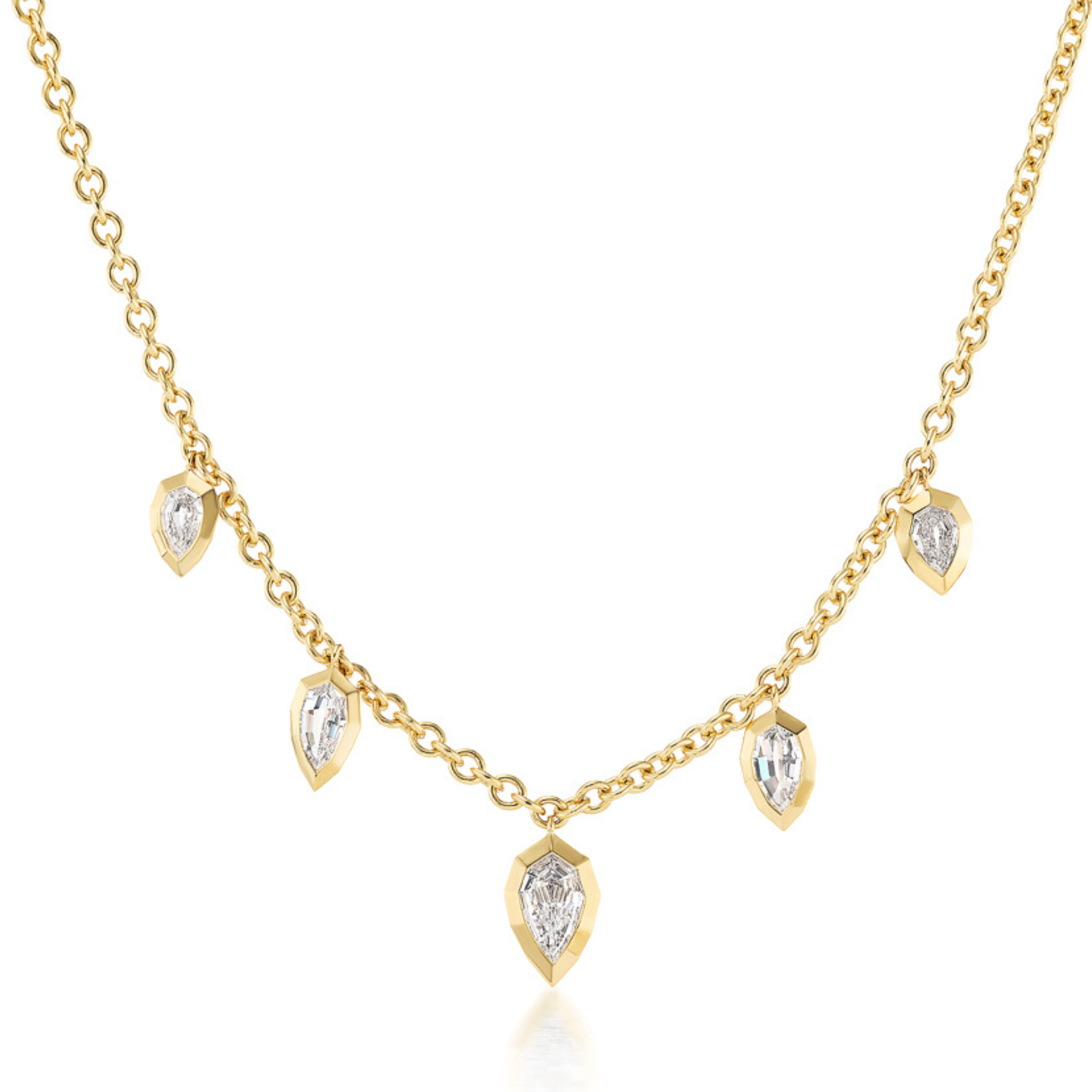 The Disco Necklace in Yellow Gold showcases step cut pear-shaped diamond charms, each set in a gold bezel and elegantly spaced along the chain for a simple yet sophisticated look.